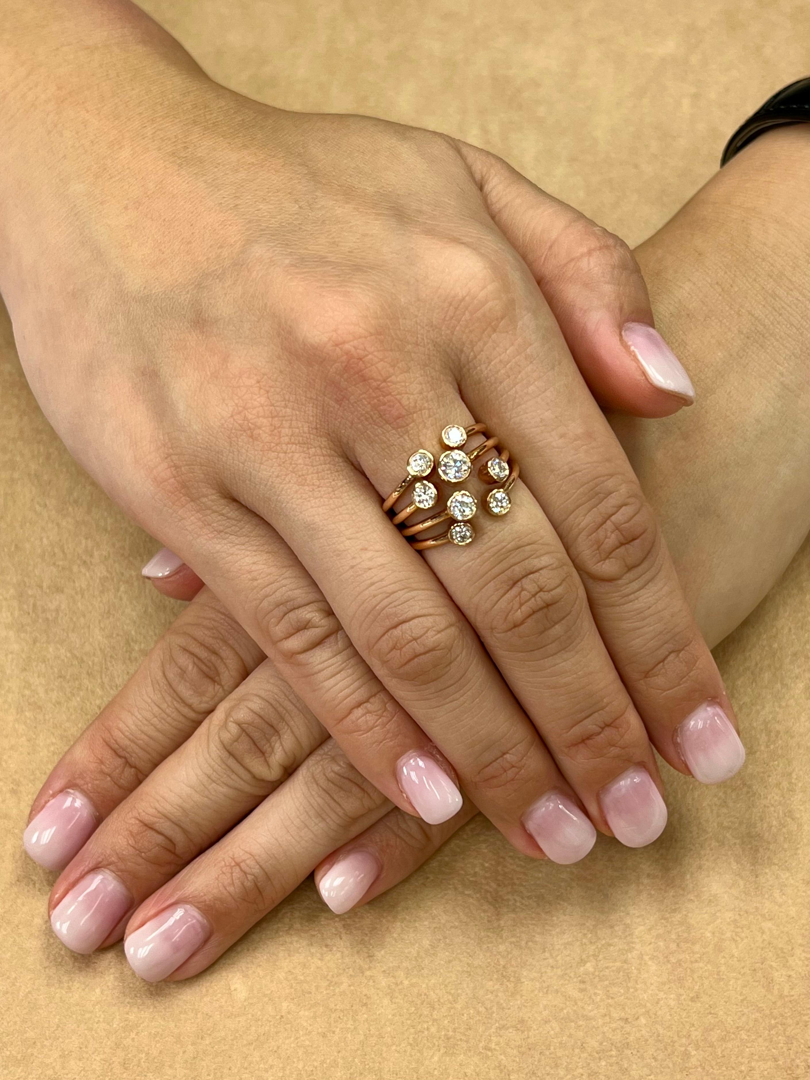 Here is a unique multi stone ring. The ring is set in 18k rose gold and diamonds. There are a combination of 8 round diamonds of various sizes that make up this ring. Average diamond size is approximately 0.135 each. This ring is full of life, lots