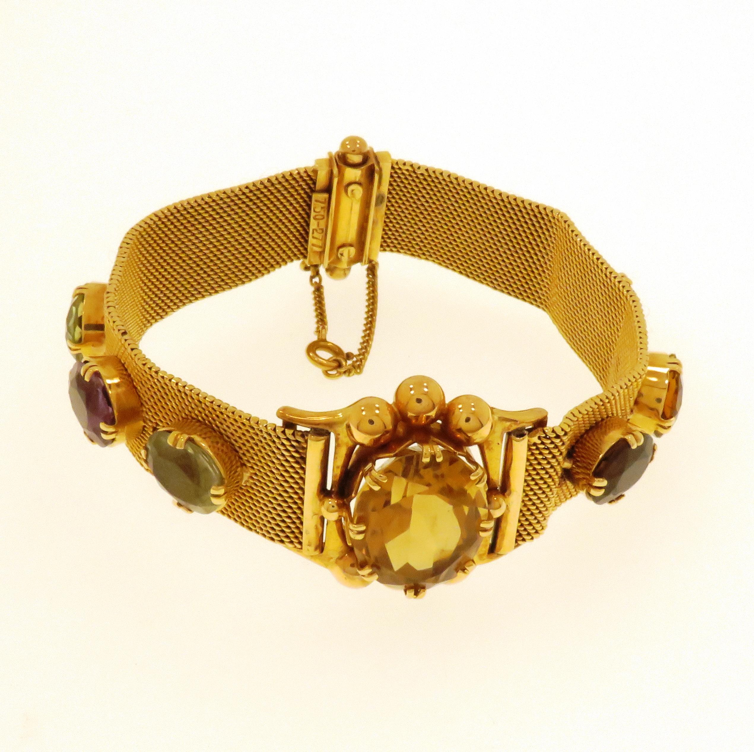 Striking vintage bracelet dating back to the 1960s. Crafted in Italy in 18k rose gold made by a band of a gold mesh embellished in the centre by a remarkable yellow topaz and decorated on each side by natural gemstones: two green tourmalines and a
