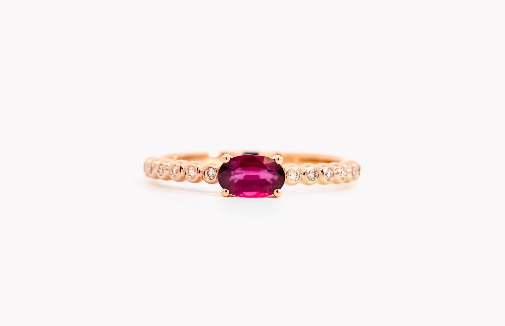 18K rose gold Ruby and Diamond ring. Set with natural gemstones and glistening 18k solid gold. Dainty 2mm thin width makes it ideal as a stacked band or wearing alone. The center stone bears a richly saturated red color and a perfectly faceted oval