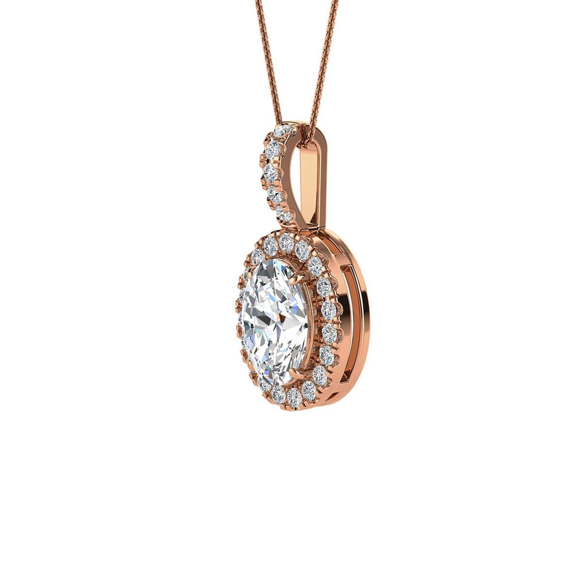 This delicate pendant features one oval-shaped diamond that is approximately 0.70-carat total weight ( 7mm x 5mm) encircled by a halo of perfectly matched 24 brilliant round diamonds in about 0.12-carat total weight. The pendant is measuring at 16