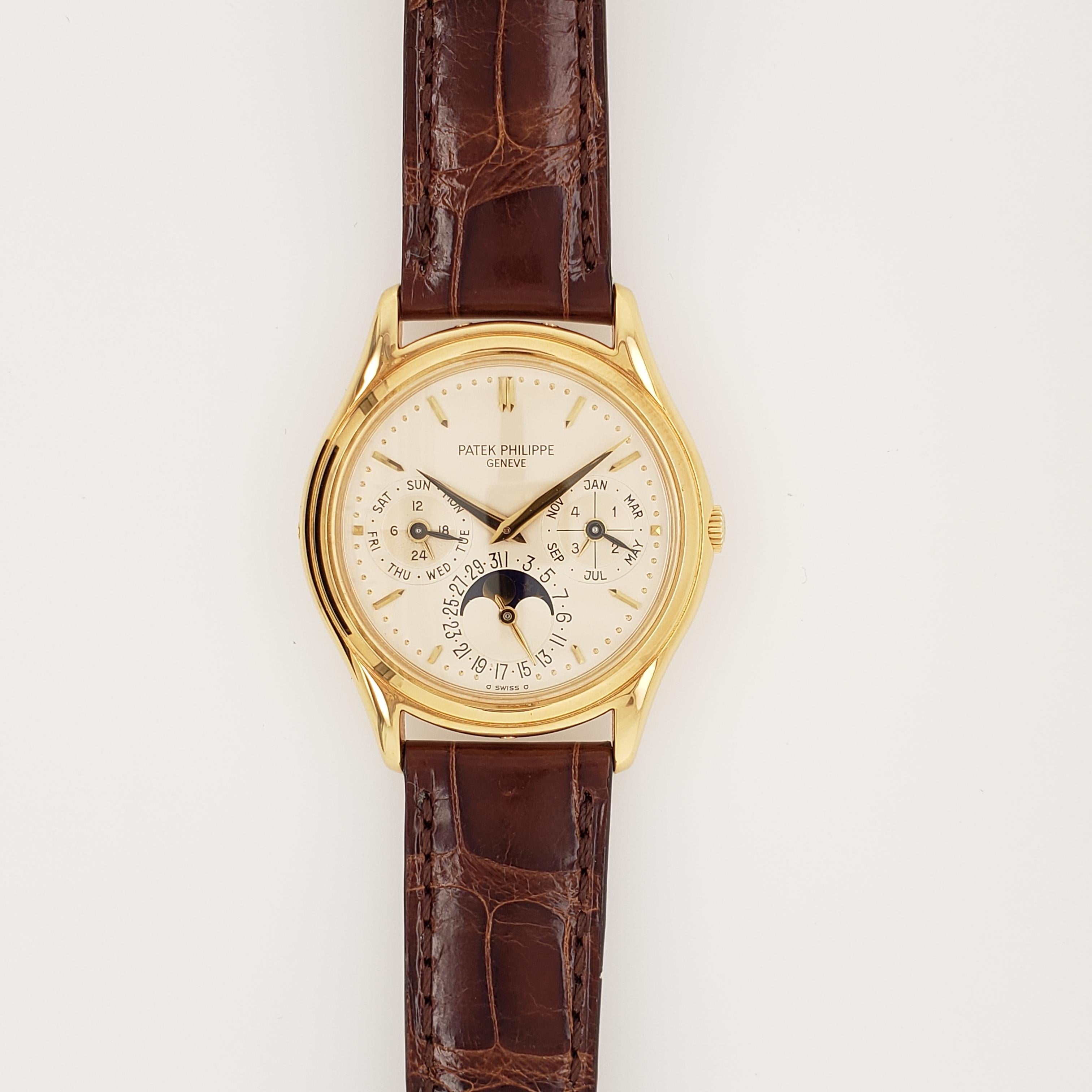 18K Rose Gold Patek Philippe Annual Calendar, Reference # 5396R-012. The watch features Moonphase, Day, Month and Date apertures. The watch is displayed on brown alligator strap with 18k Rose Gold Patek Philippe deployment  buckle. Watch is in mint,