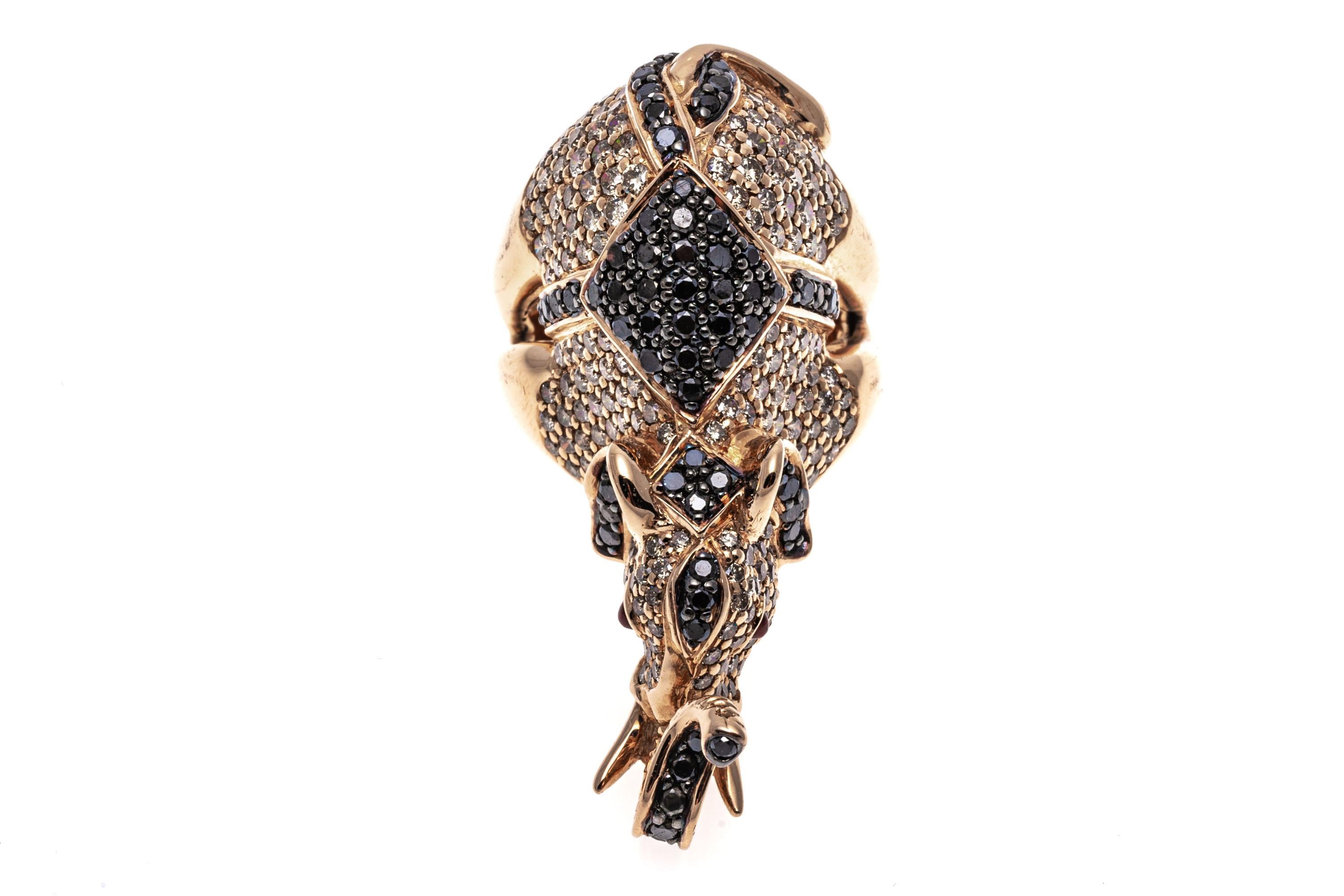 18k rose gold ring ring. This beautiful ring is a fanciful balancing elephant, the body trimmed in the entirety with pave set, round faceted, cognac diamonds approximately 2.06 TCW, and decorated with a saddle and trim of round faceted black