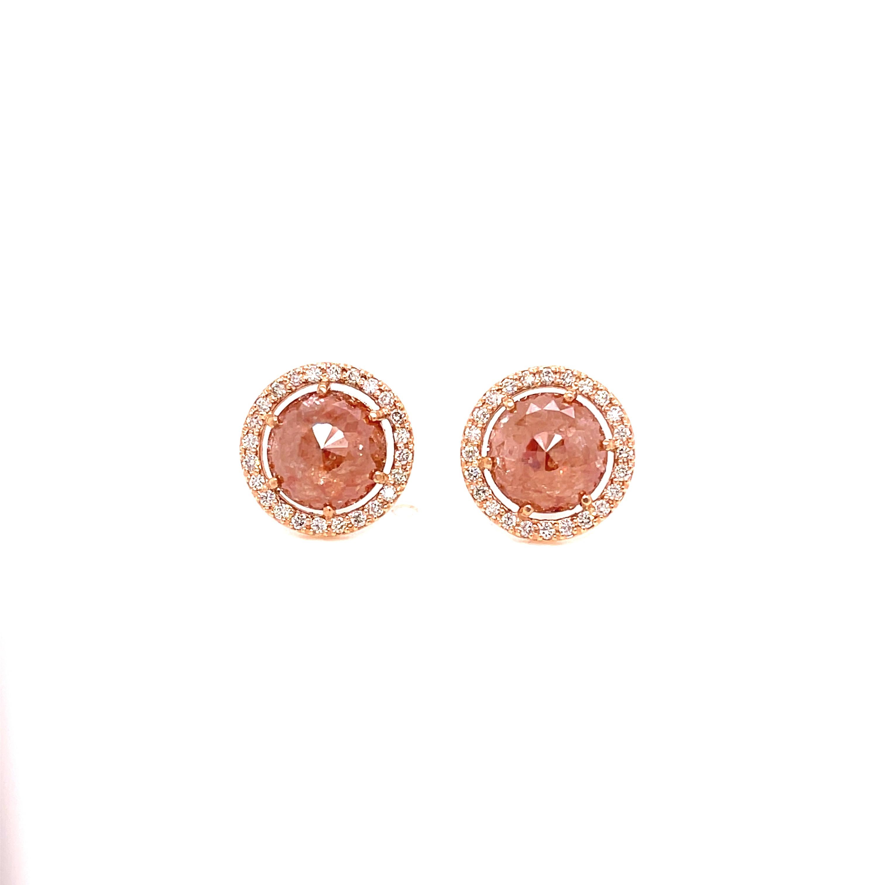 A pair of 18K rose gold studs set with 2 pinkish brown 4.35ct. rose cut diamonds and .38tcw. of top light brown faceted diamonds in a halo around the diamonds, with a pair of 18K rose gold removable earring jackets with 7.67ct. pear shaped black