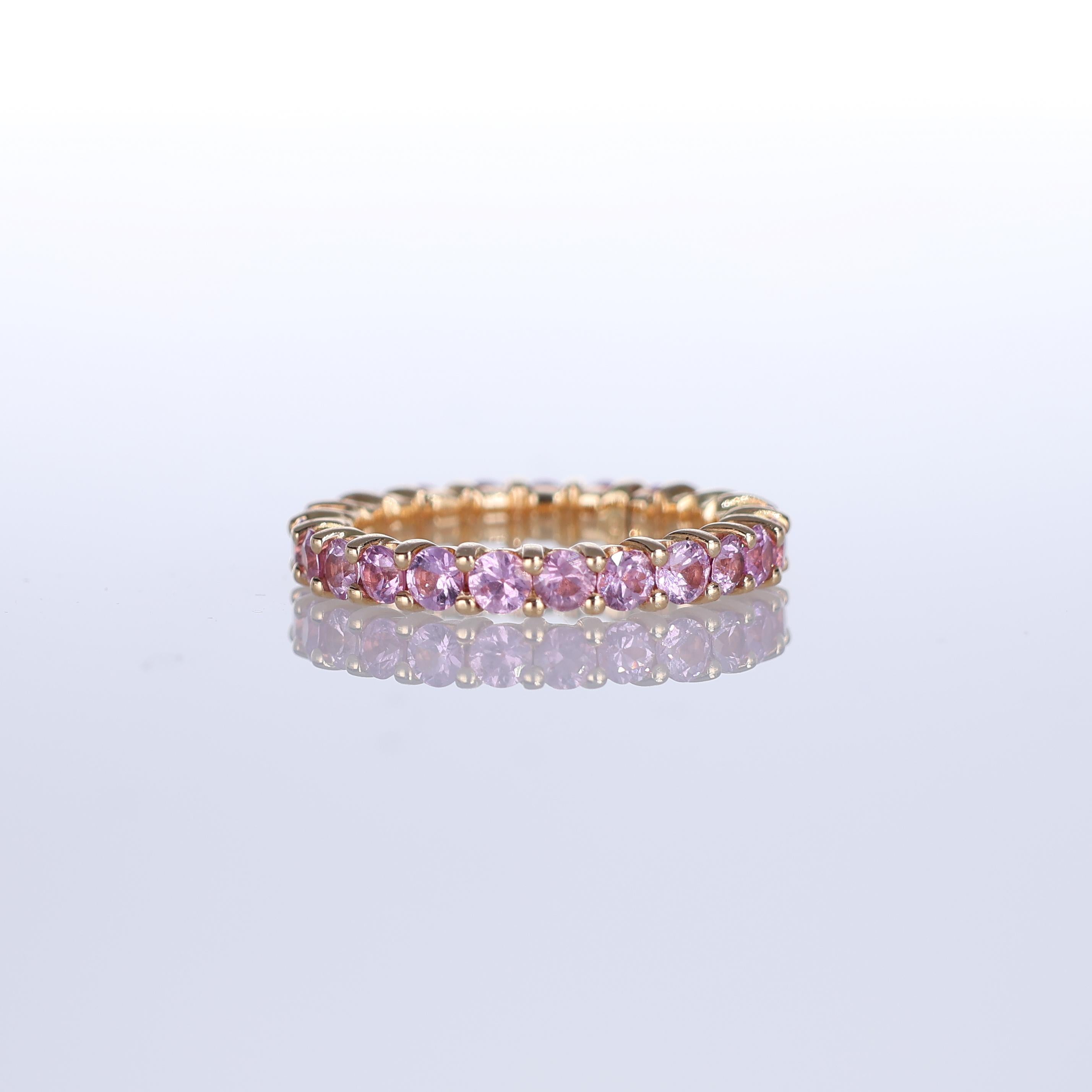 A delicate yet radiant eternity band crafted in 18K rose gold, fully set with 2.92 carats of vivid pink sapphires. The warmth of rose gold enhances the soft, feminine hue of the sapphires, creating a refined and timeless piece. Designed for those