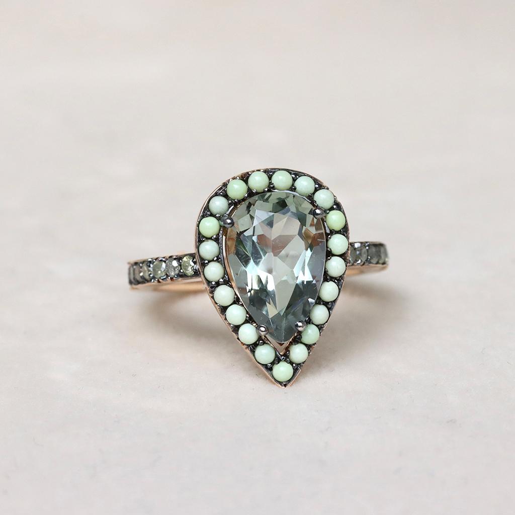 Introducing the Twilight Ring: A one-of-a-kind 18K Rose gold masterpiece. Featuring a pear-shaped Prasiolite centerstone, Lemon Chrysophrase cabochons, and fancy yellow icy diamonds in the black rhodium-plated setting. Handmade with no casting, this