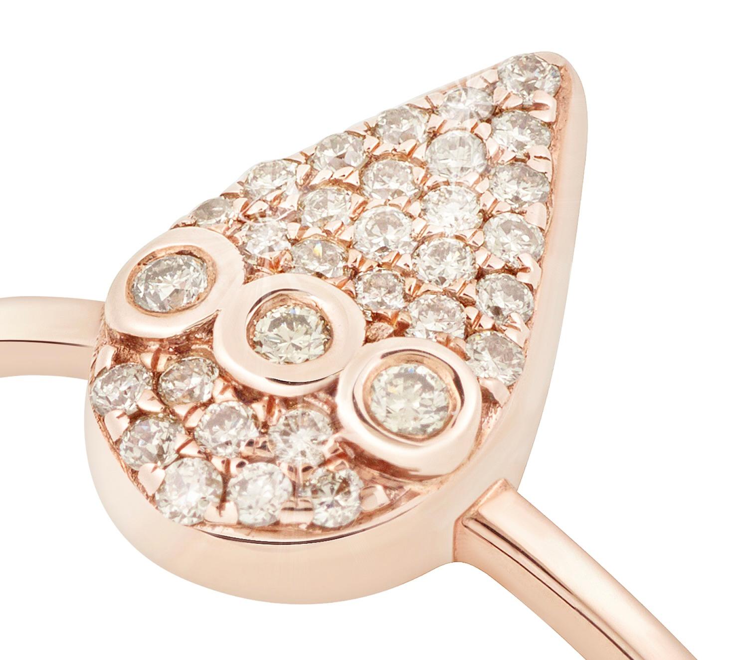 This stunning, flat-drop ring in shimmering 18k rose gold evokes the wonder of nature as it glistens like a water droplet, pristine and pure in the morning's soft embrace. Its pavé-style arrangement of champagne diamonds is crafted with meticulous