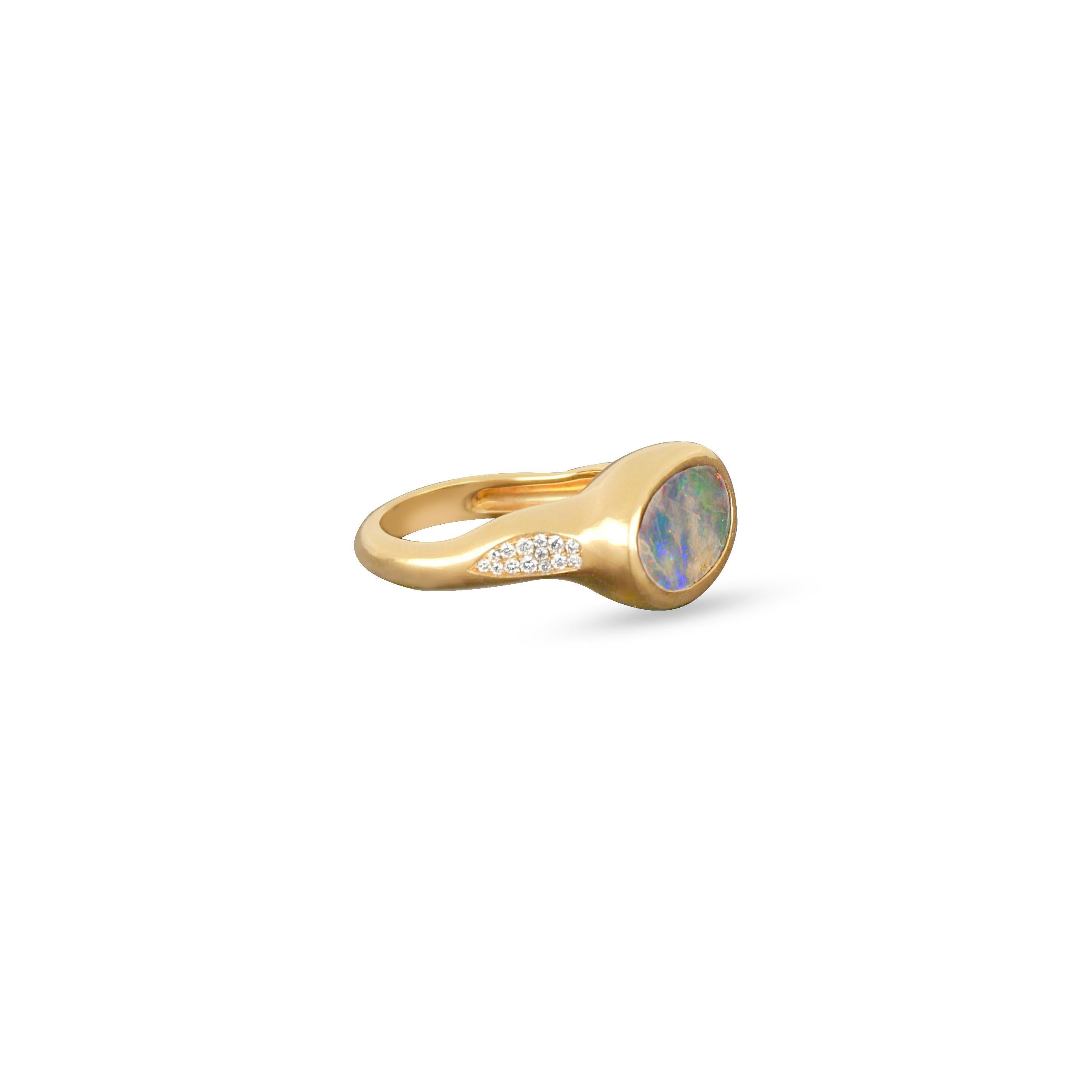 This exquisite 18K rose gold ring features a mesmerising opal centre stone, reminiscent of a celestial galaxy with its play of colours. Surrounding the opal are delicate round cut diamonds, adding a touch of sparkle that enhances the celestial