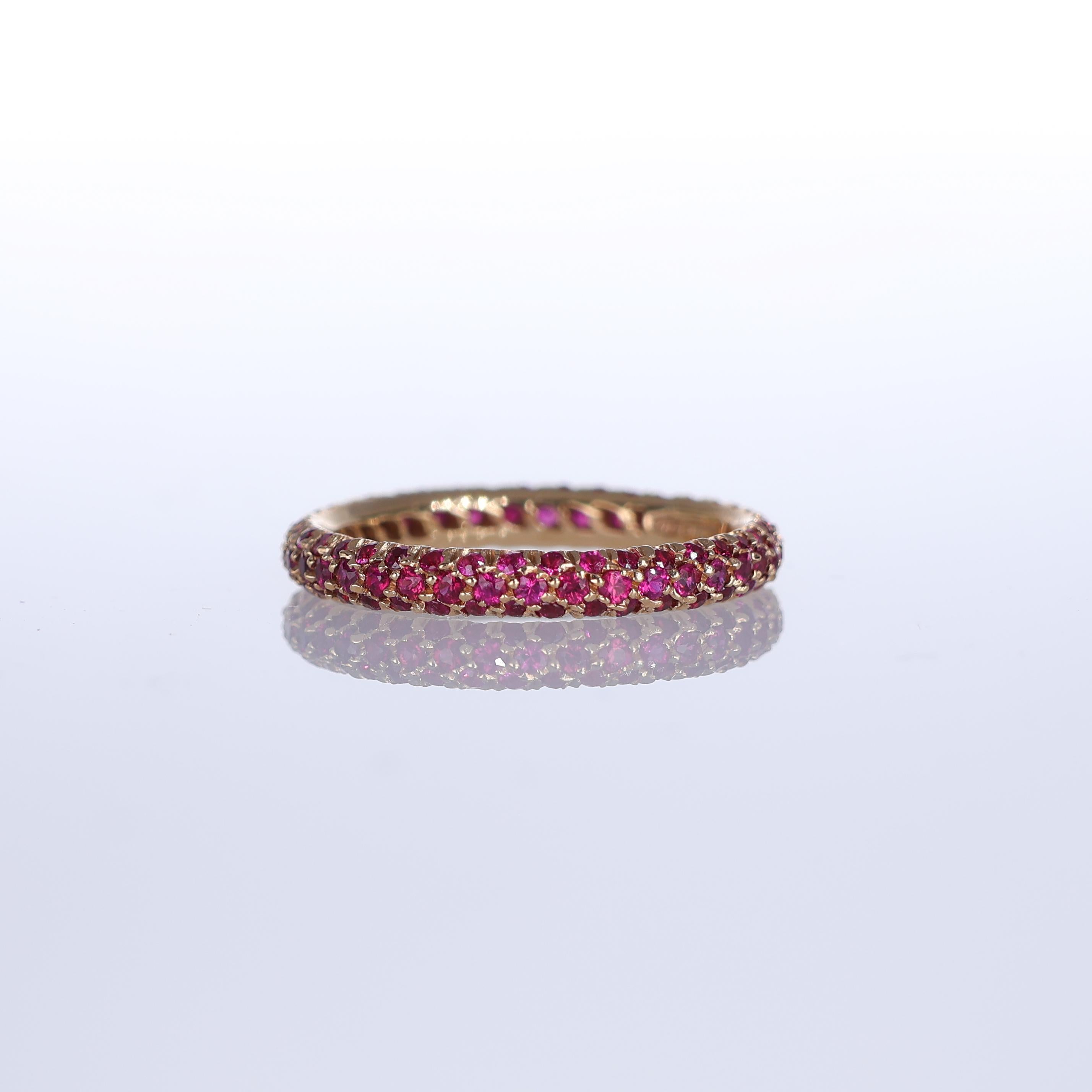 A refined band ring crafted in 18K rose gold, featuring a pavé of rubies totaling 1.37 carats. The vibrant red hue of the rubies is beautifully complemented by the warm tones of the gold, creating a striking yet elegant piece. Perfect for those who