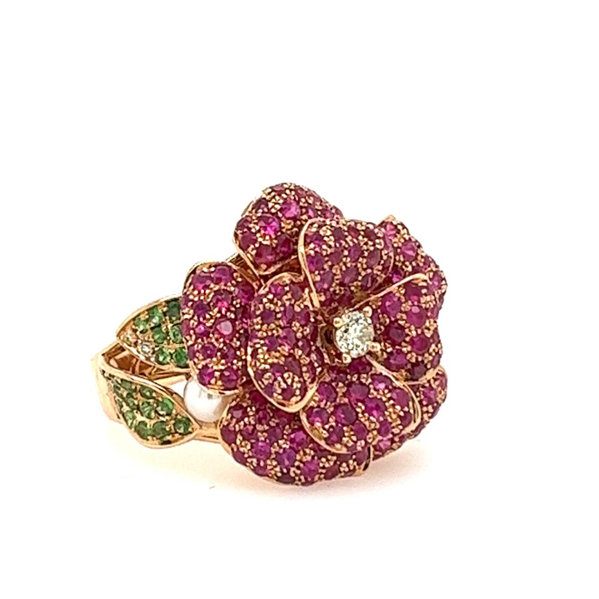 18K Rose Gold Ruby & Pearl Flower Ring with Diamonds

170 Rubies - 2.43 CT
1 Pearl - 0.27 CT (3.4MM)
39 Green Garnets - 0.36 CT
7 Diamonds - 0.14 CT
18K Rose Gold - 9.20 GM

Captivating in its elegance, this stunning flower-shaped ring is a