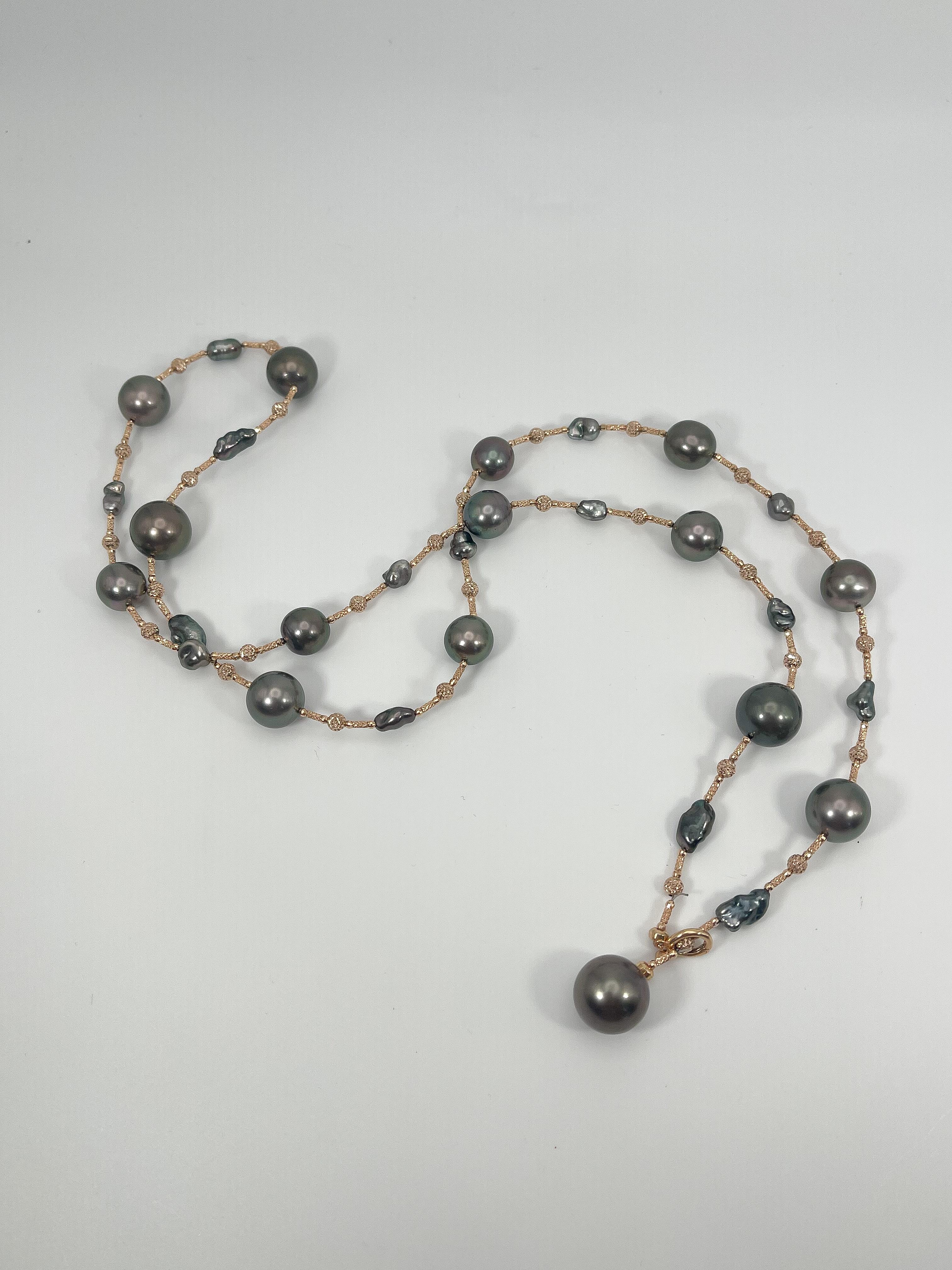 18K Rose gold south sea Tahitian pearl necklace. The pearls are 11mm, has a pearl clasp to close necklace, the necklace is 32 inches long, can be worn in 7 different ways, has a total weight of 53.3 grams.