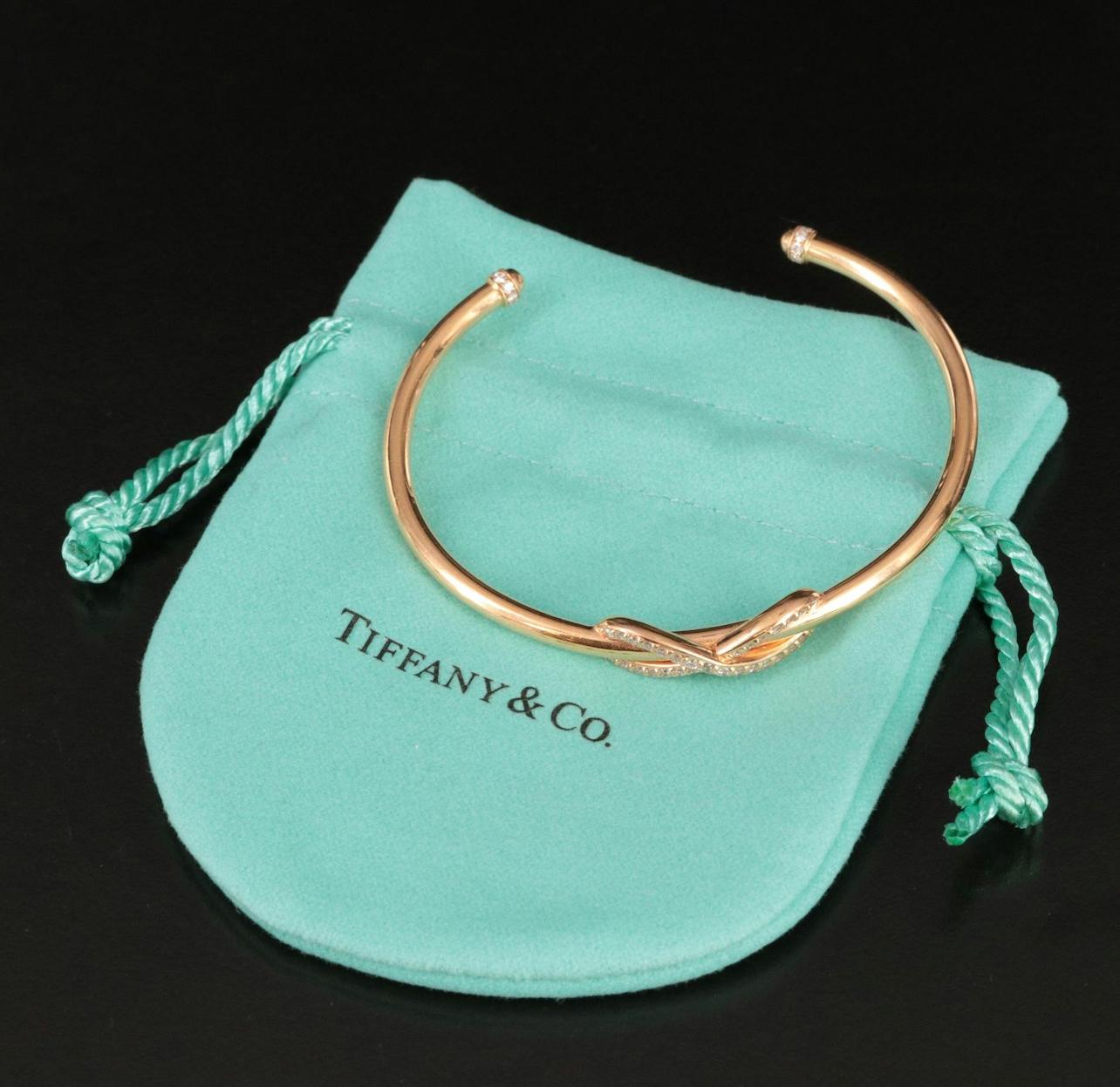 Tiffany & Co.
Retail $4750
Outstanding Condition 
Very minor surface scratches only visible with magnification
Diamonds throughout the infinity and the ends of the cuff
Brand/Designer:	Tiffany & Co.
Materials:	18K Gold
Bracelet Length:	6.00