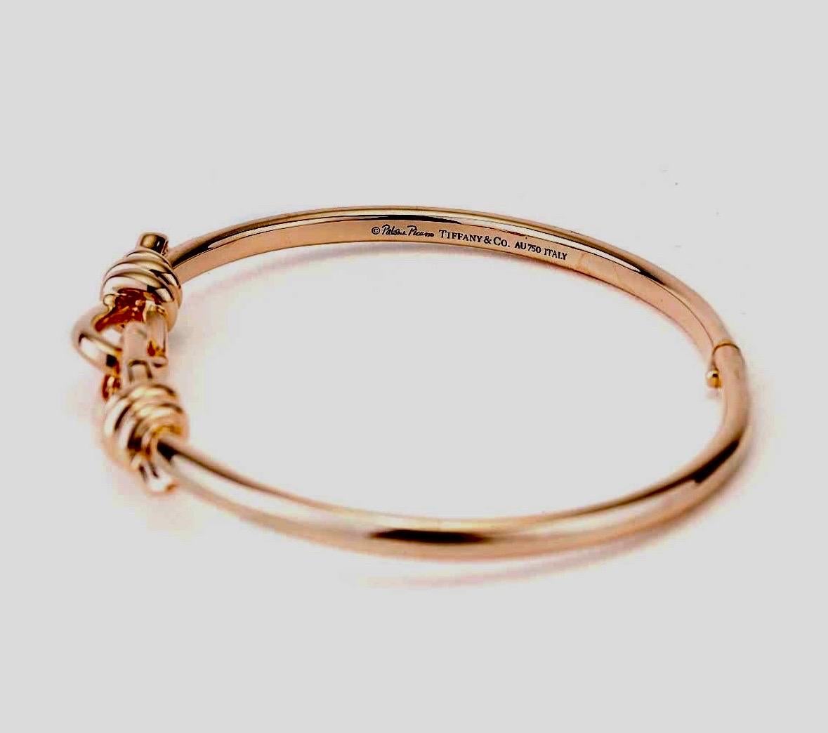 DeKara Design Designer Collection 

Metal- 18K Rose Gold, .750.  32.3 Grams.

Authentic Tiffany & Co Paloma Picasso Love Knot Hinged Bangle Created in 18K Rose Gold. This bracelet is specially made in Italy for the European market, and is hard to
