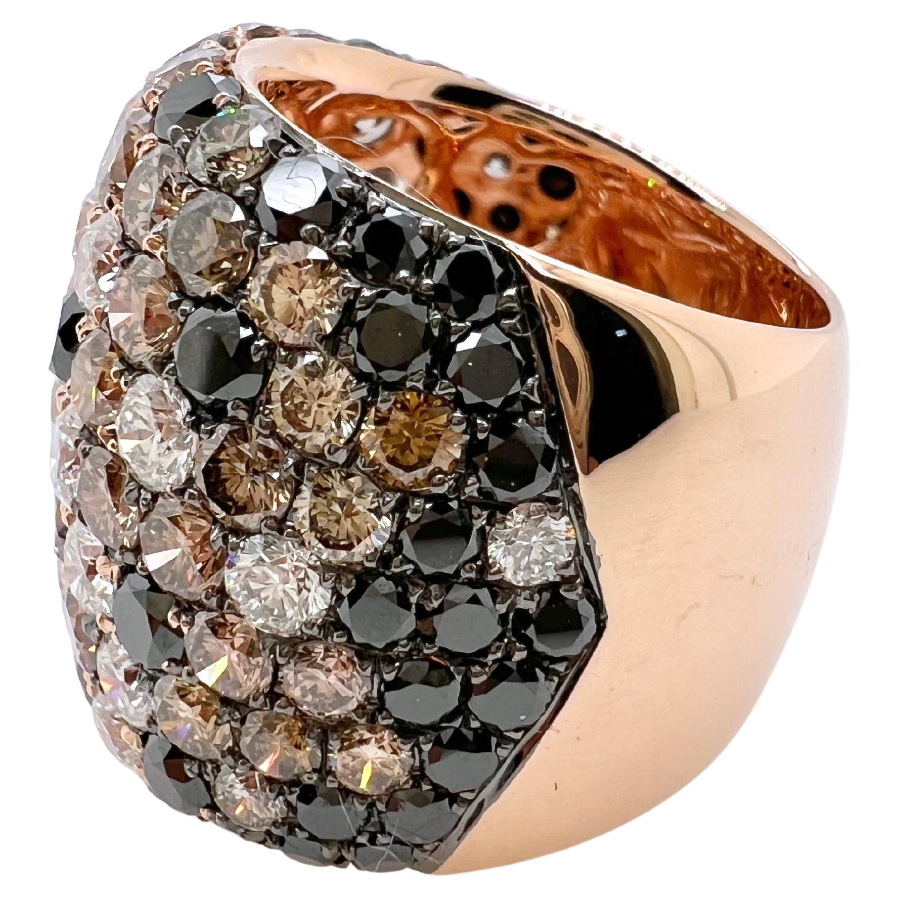 This gorgeous diamond ring has round brilliant diamonds scattered in an unusual pattern that consists of white, brown, and black diamonds.  This masterpiece is set in 18k rose gold and we have named it volcano.  This ring will definitely be the talk