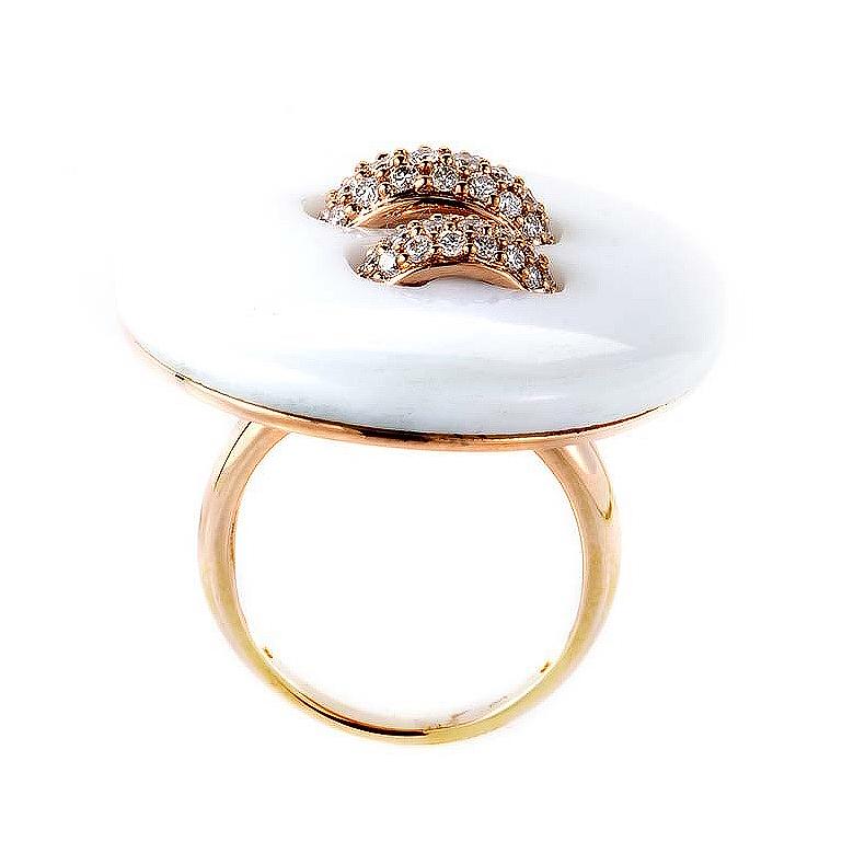 This ring is cute as a button, and shaped like one too! It is made of 18K rose gold and boasts a button-shaped motif made of white onyx and accented with ~.72ct of diamonds.
Ring Size: 6.25