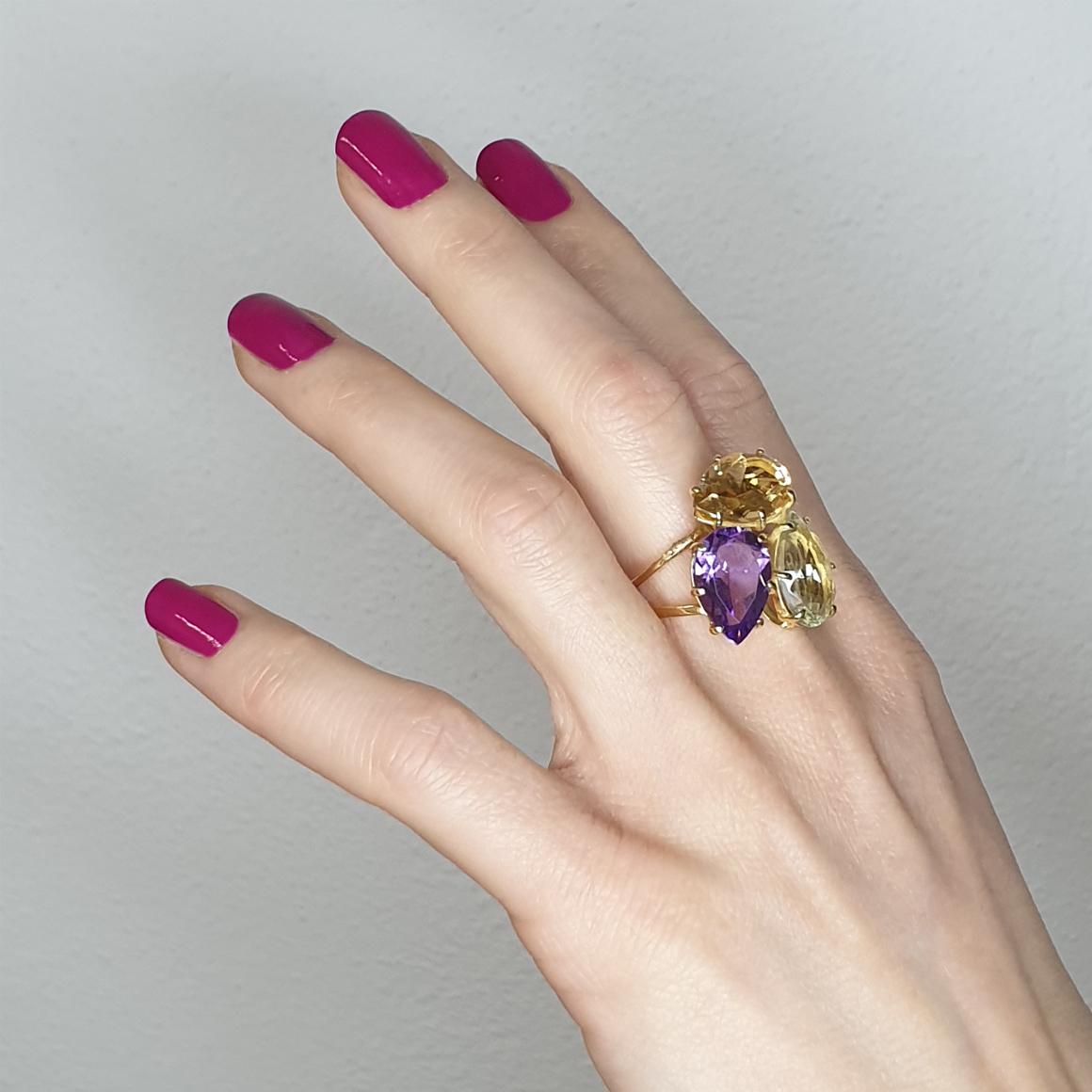 Intertwining of the same shapes with different colors create a very trendy Ring, Italian art jewels by Stanoppi Jewellery since 1948.

Ring in 18k rose gold with Amethyst (drop cut, size: 10x15 mm), Citrine (drop cut, size: 10x15mm) and Prasiolite