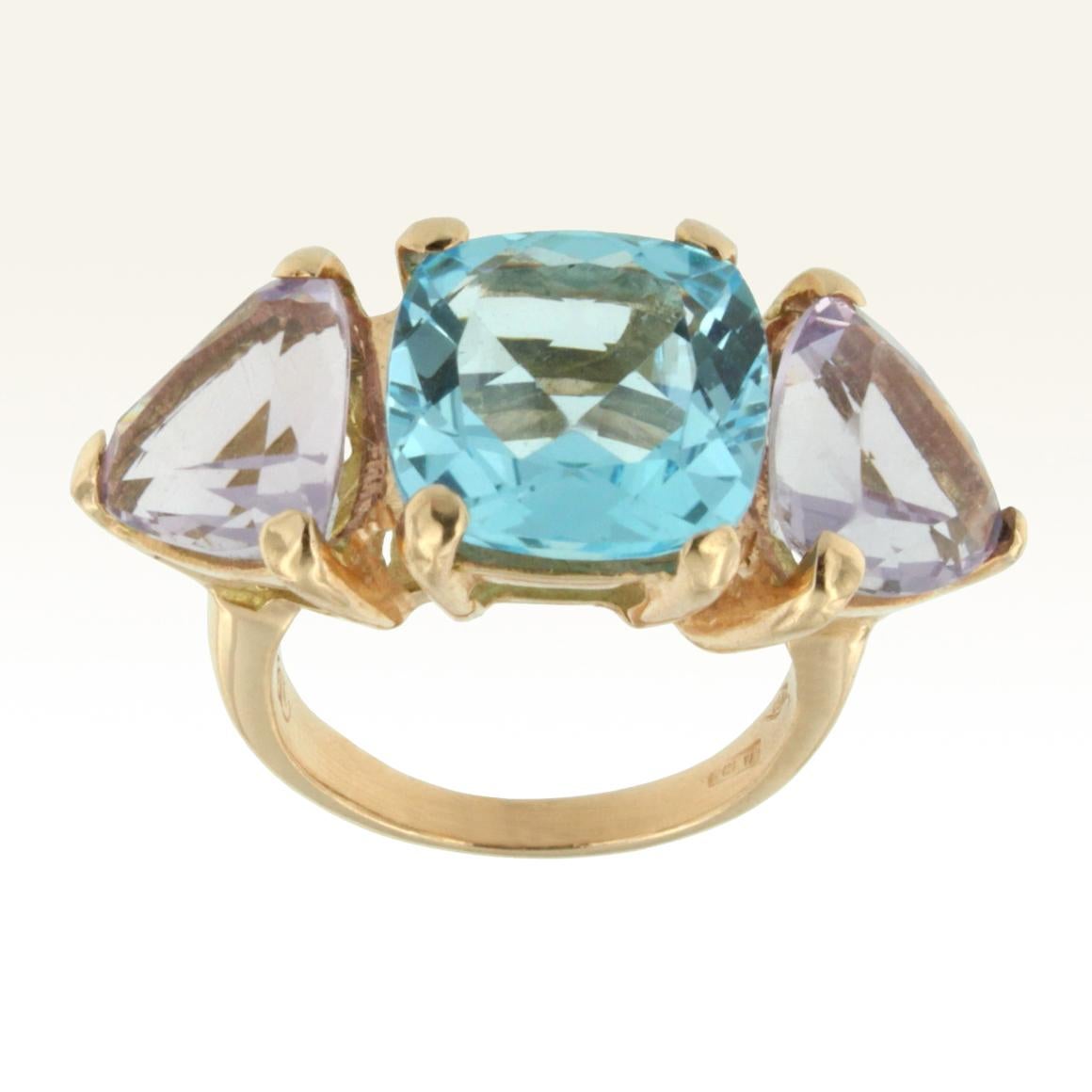 Ring in 18k rose gold with Blue Topaz (square cut, size: 12x12 mm) and light Amethyst (trianglular cut, size: 10x10 mm)
Don't you love the cocktail rings? We love them very much, we love the colour . Gorgeous ring with special blue topaz  and