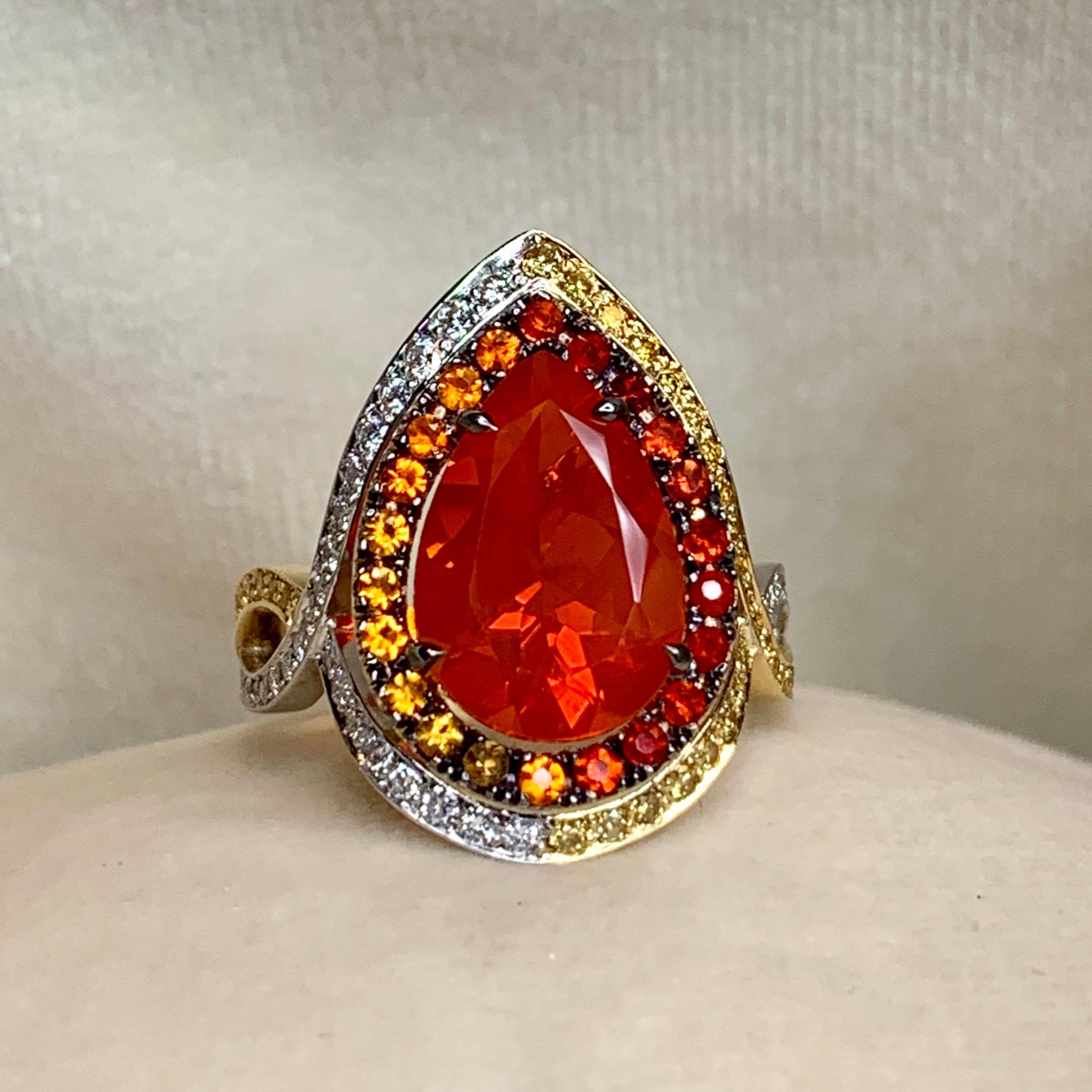 One of a kind ring in 18K Rose, Yellow & White gold 7,3 g. Ring set with a pear shaped fire opal centerstone 2,78 carat., surrounding stones: Fire opal, white diamonds DEGVVS and fancy yellow diamonds. Surrounding diamonds: 0,68 carat. Handmade the