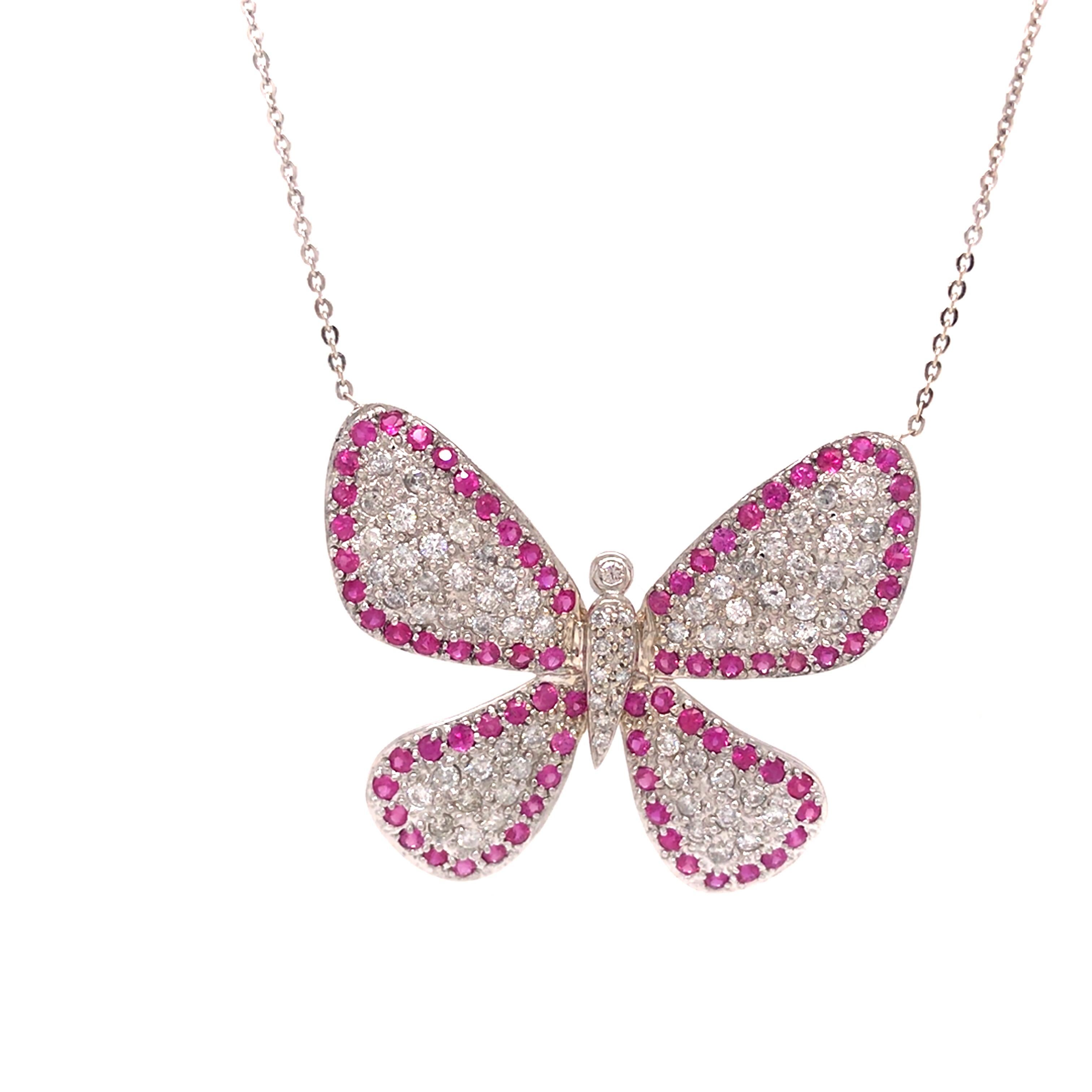 Ruby and Diamond Butterfly Pendant Necklace in 18K White Gold. Round Brilliant Cut Diamonds weighing 1.53 carat total weight, G-H in color, SI-I2 in clarity and (80) Ruby Gemstones weighing 1.60 carat total weight are expertly pave set.  The