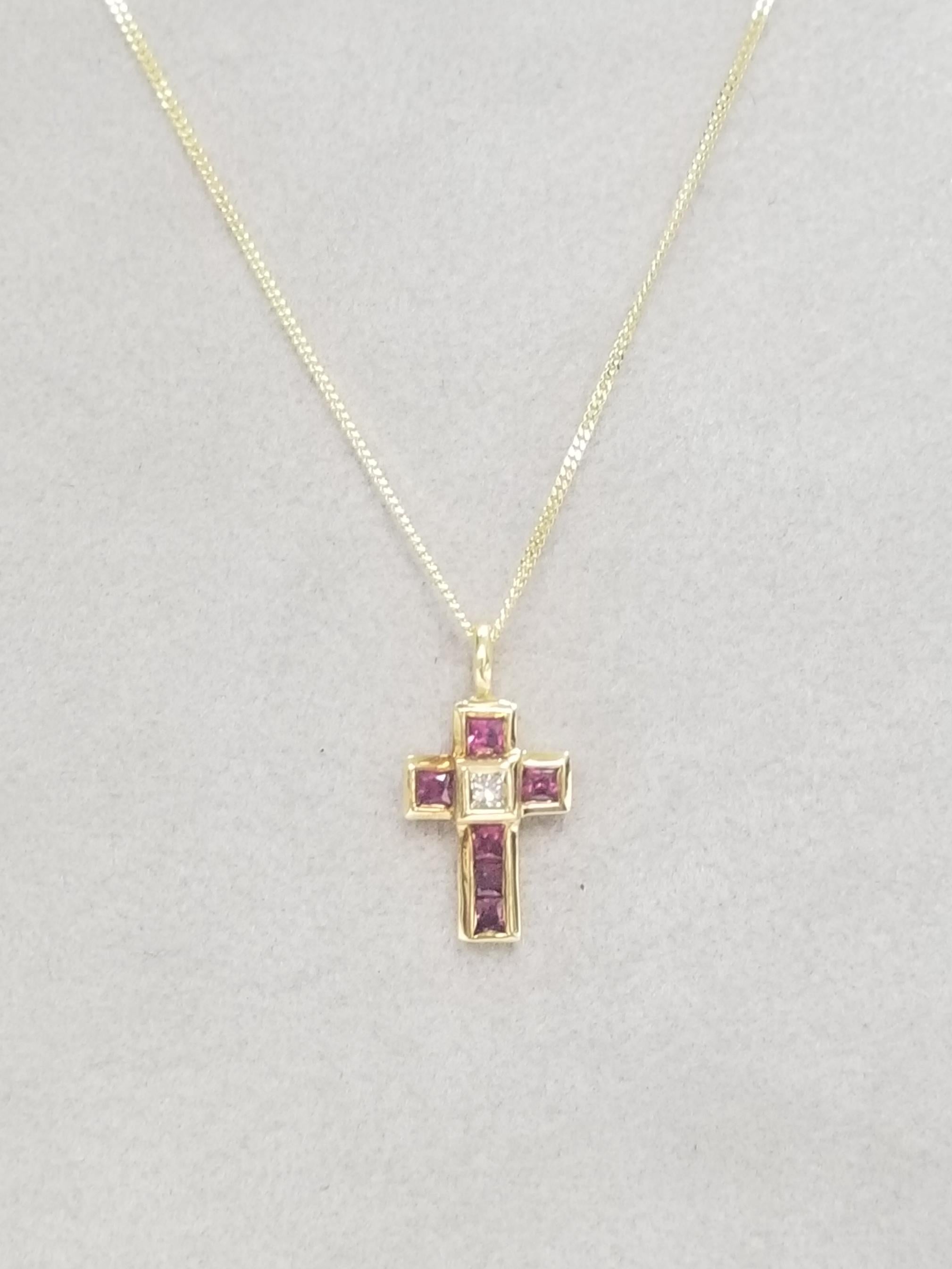 18k yellow gold ruby and diamond pendant containing 6 princess cut rubies of gem quality weighing .50pts. and 1 princess cut diamond of very fine quality weighing .10pts. on a 14k yellow gold 18 inch chain.