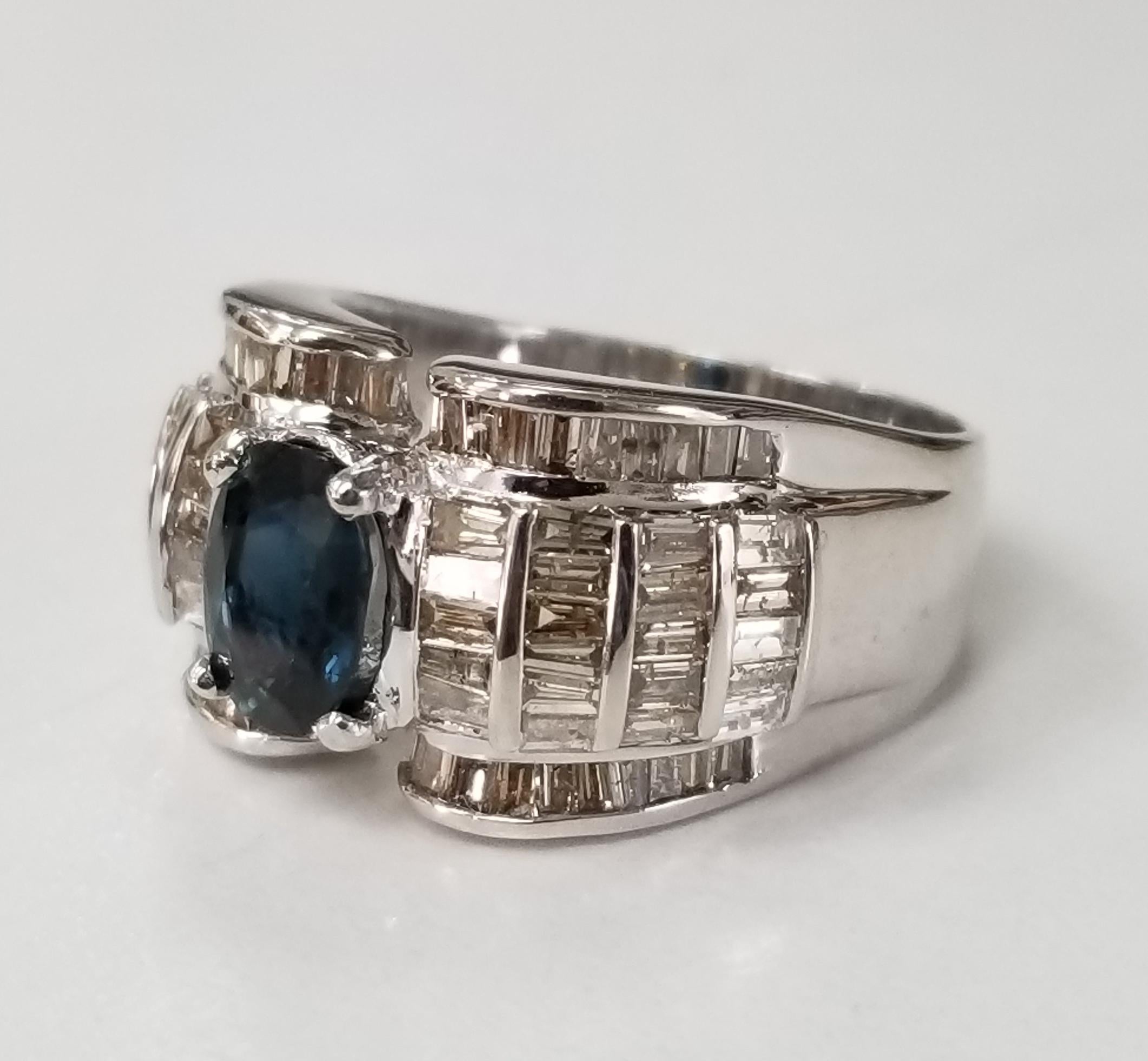 18k white gold sapphire and diamond baguette ring, containing 1 oval cut sapphire weighing1.25cts. and 86 baguette cut diamonds weighing 1.55cts.  This ring is a size 6.5 but we will size to fit for free.