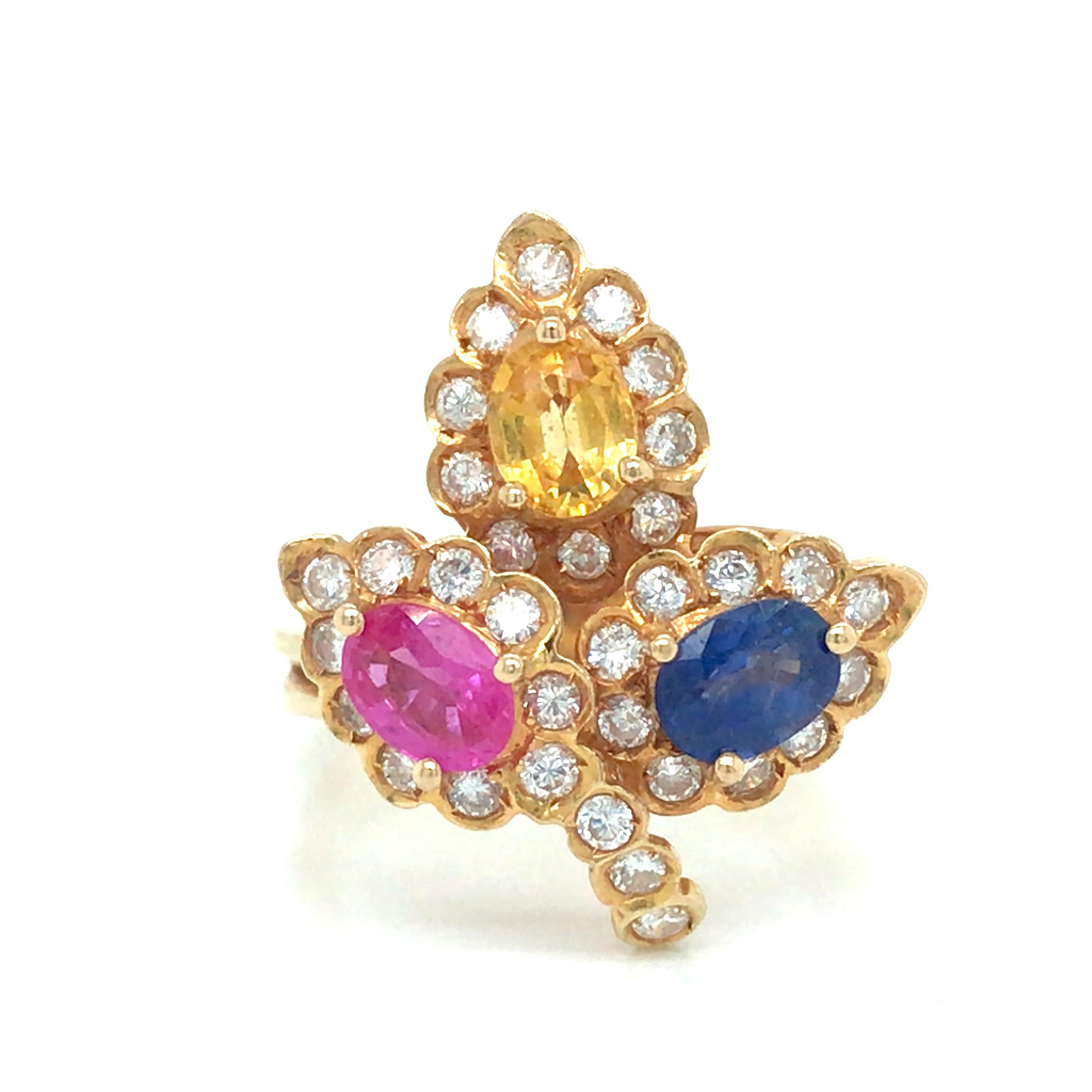 Sapphire Diamond Flower Cluster Ring in 18K Yellow Gold.  Yellow, Pink and Blue Pear Shape Sapphires weighing 1.50 carat total weight and (33) Round Brilliant Cut Diamonds weighing 0.66 carat total weight are expertly set.  The Ring measures 7/8
