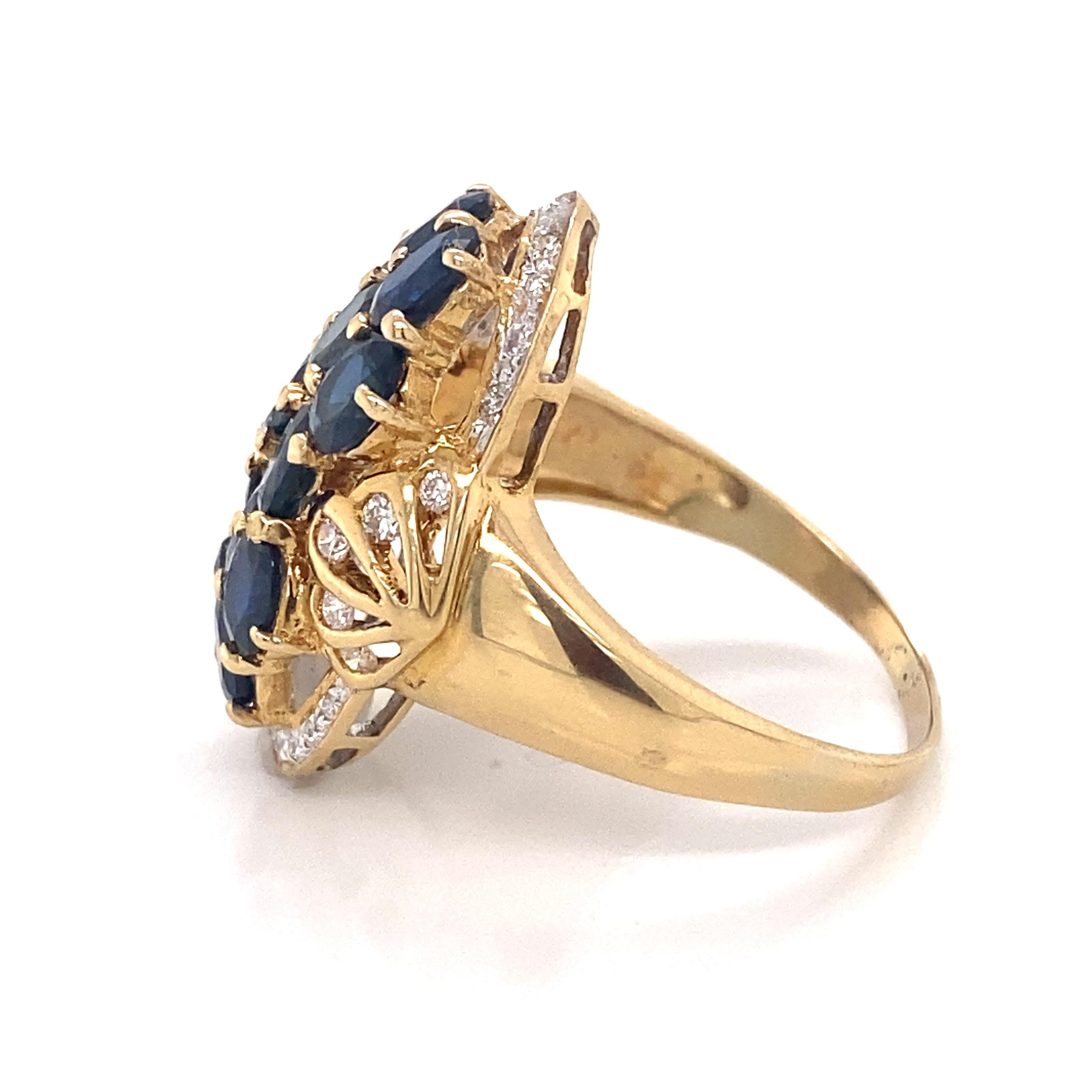 A lovely setting of rich, deep colored sapphires with diamonds in an 18k yellow gold ring. There are twelve individually set sapphires weighing approximately 4.8 ctw (measured in setting). The ring is a size 9.75 but can easily be resized. 