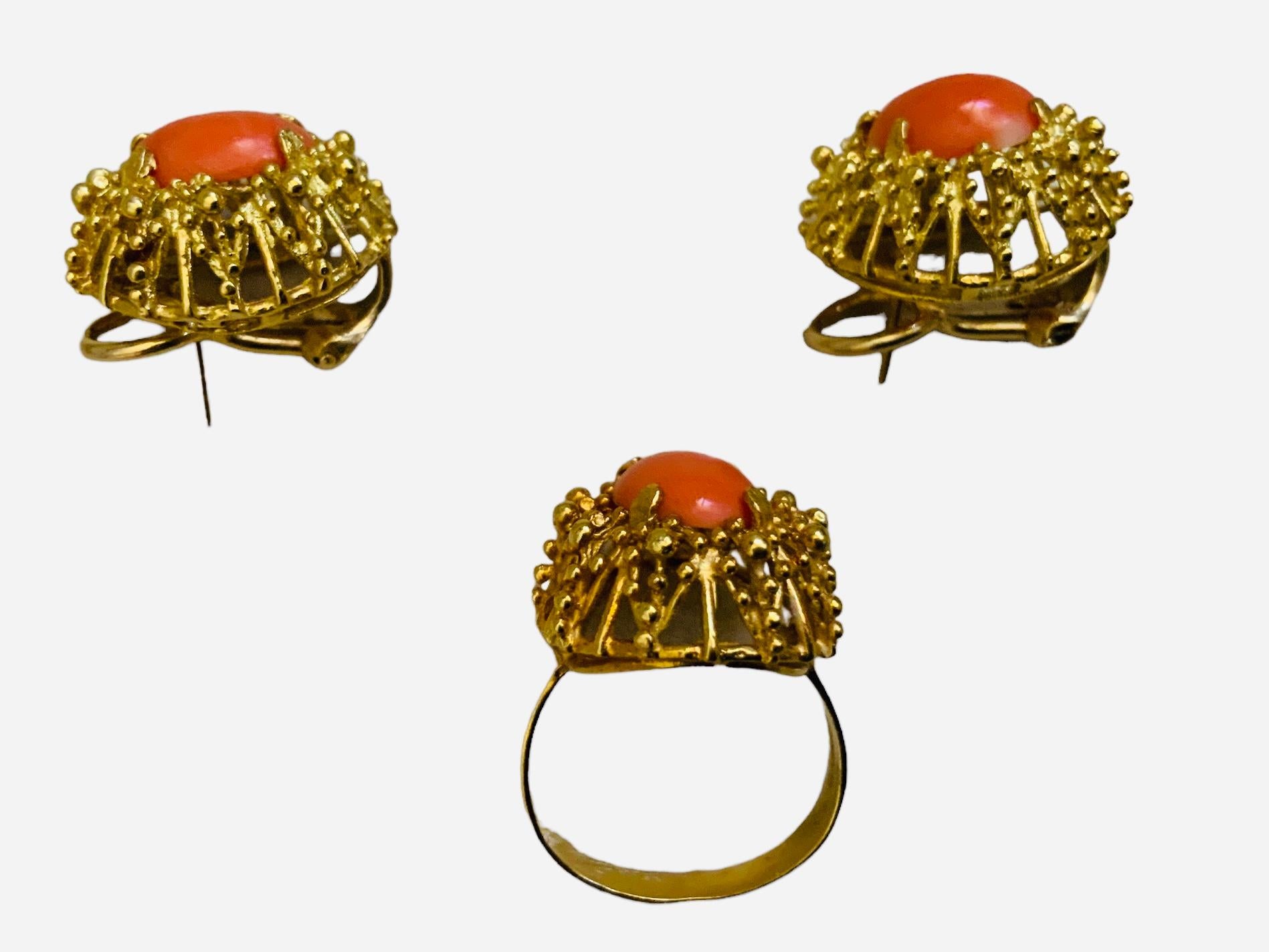 This is a Set of 18K yellow gold Corletto Coral Earrings and Cocktail Ring. It depicts an oval shaped cabochon small Coral mounted in gold prong setting and surrounded by a wreath made of spikes with tiny beads. The ring is signed Italy and 18K in