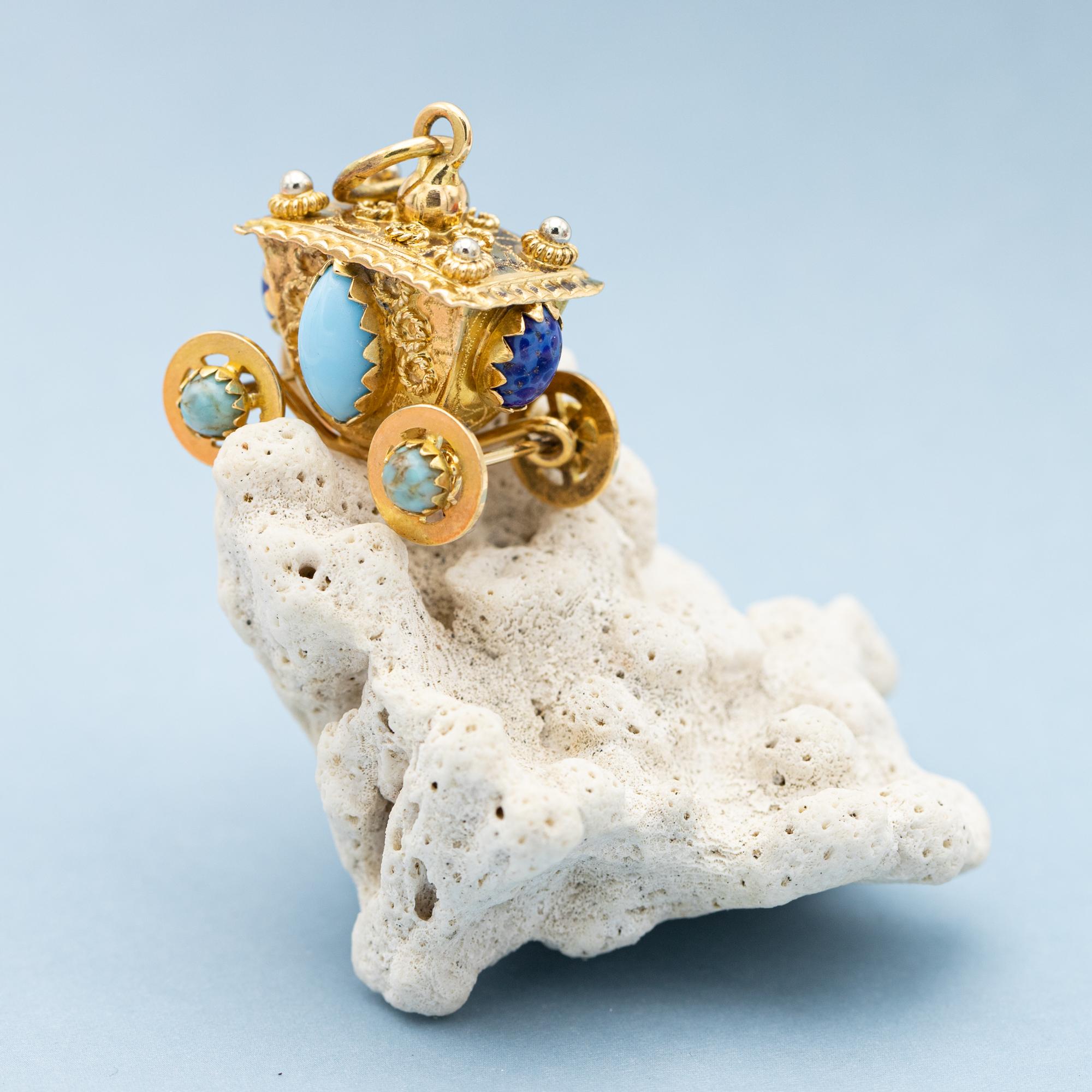 This stunning Italian charm is crafted in 18 ct yellow gold and set with eight cabochon gemstones of which two are dark, sometimes speckled, blue. The other six are turquoise. This wonderful and magnificent hand made vintage carriage pendant is
