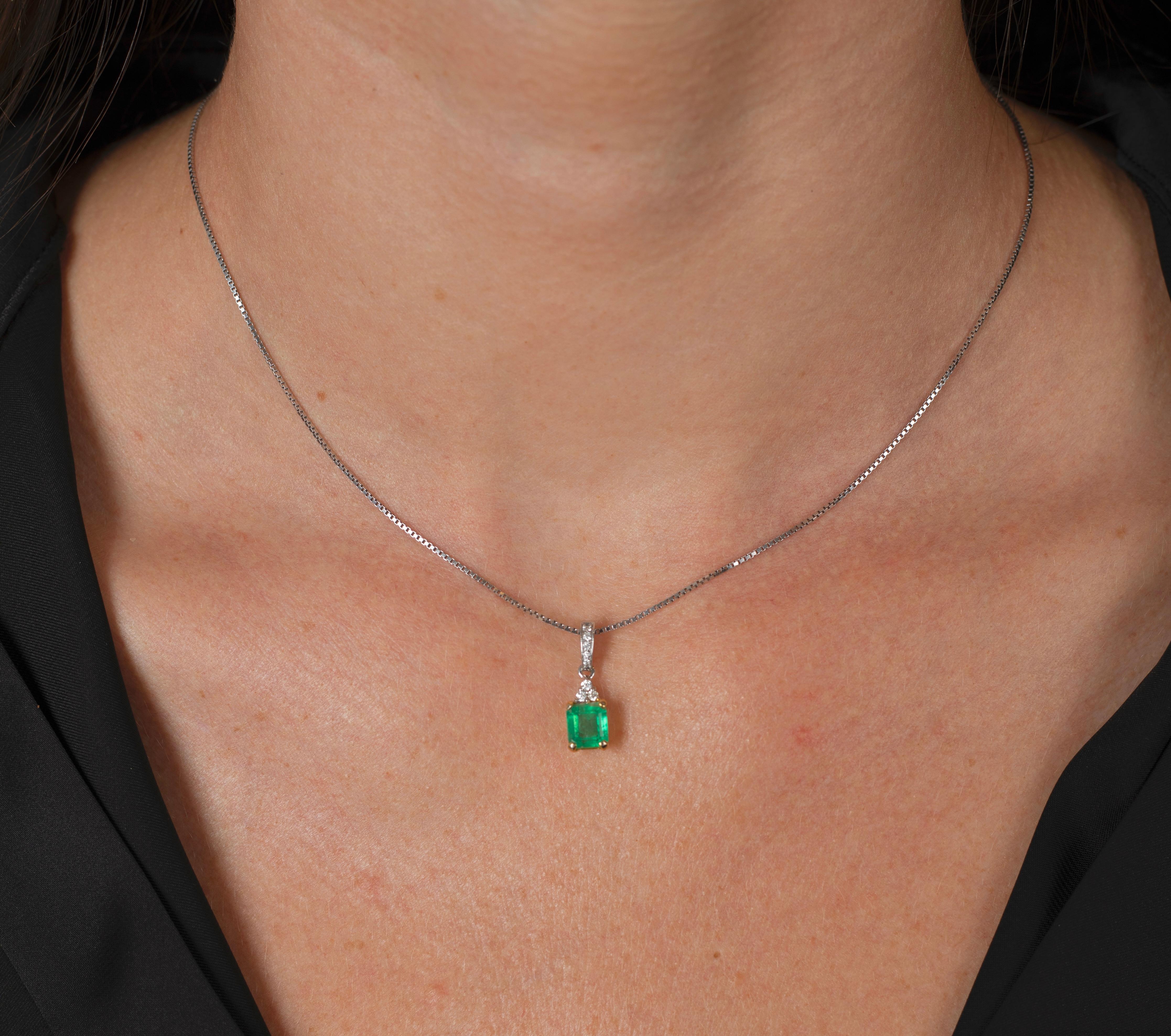 FEATURES: 18K solid gold, natural Colombian emerald, natural mined diamonds, and a certificate of appraisal. 

18-karat solid white and yellow gold pendant mounts a 1.23 carat natural Colombian emerald. The pendant features a dynamic bail that