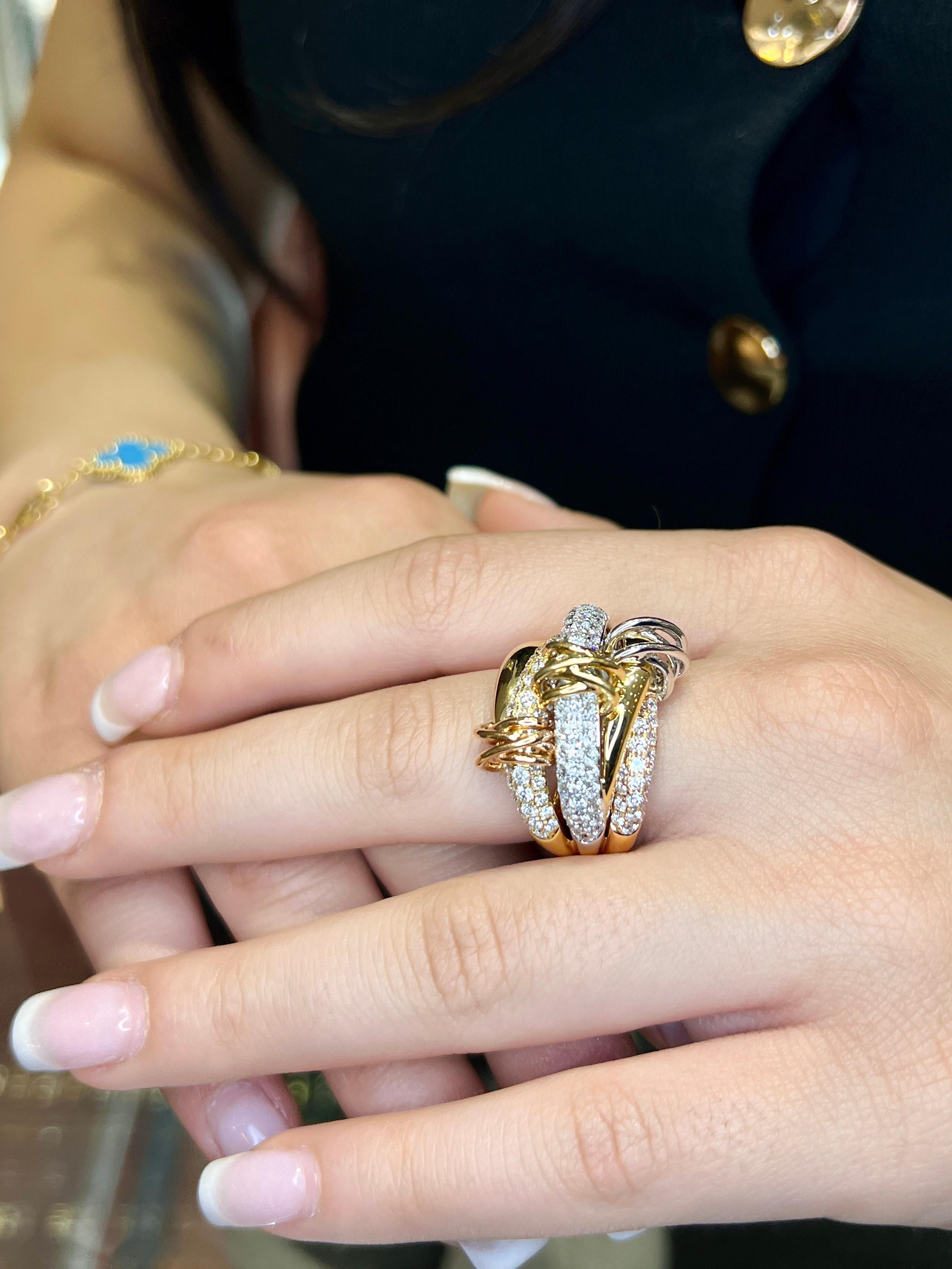 An Italian style tricolor trinity Ring, 18k gold (750 hallmark). Beautiful Tri-color motif, bombe style ring, featuring spirals/knots, Rose gold, yellow gold, and white gold on top of pavé rows of diamonds totaling 3.00 carats. The ring is made up