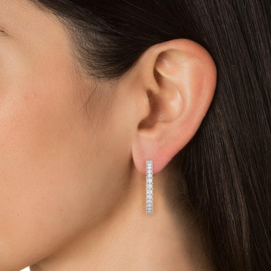 C-Hoop Moissanite Earrings in 18k solid white gold. You shall need these hoop earrings to make a statement with your look. These Moissanite hoop earrings create a sparkling, luxurious look featuring 0.92 carats of moissanite.
Moissanite attracts