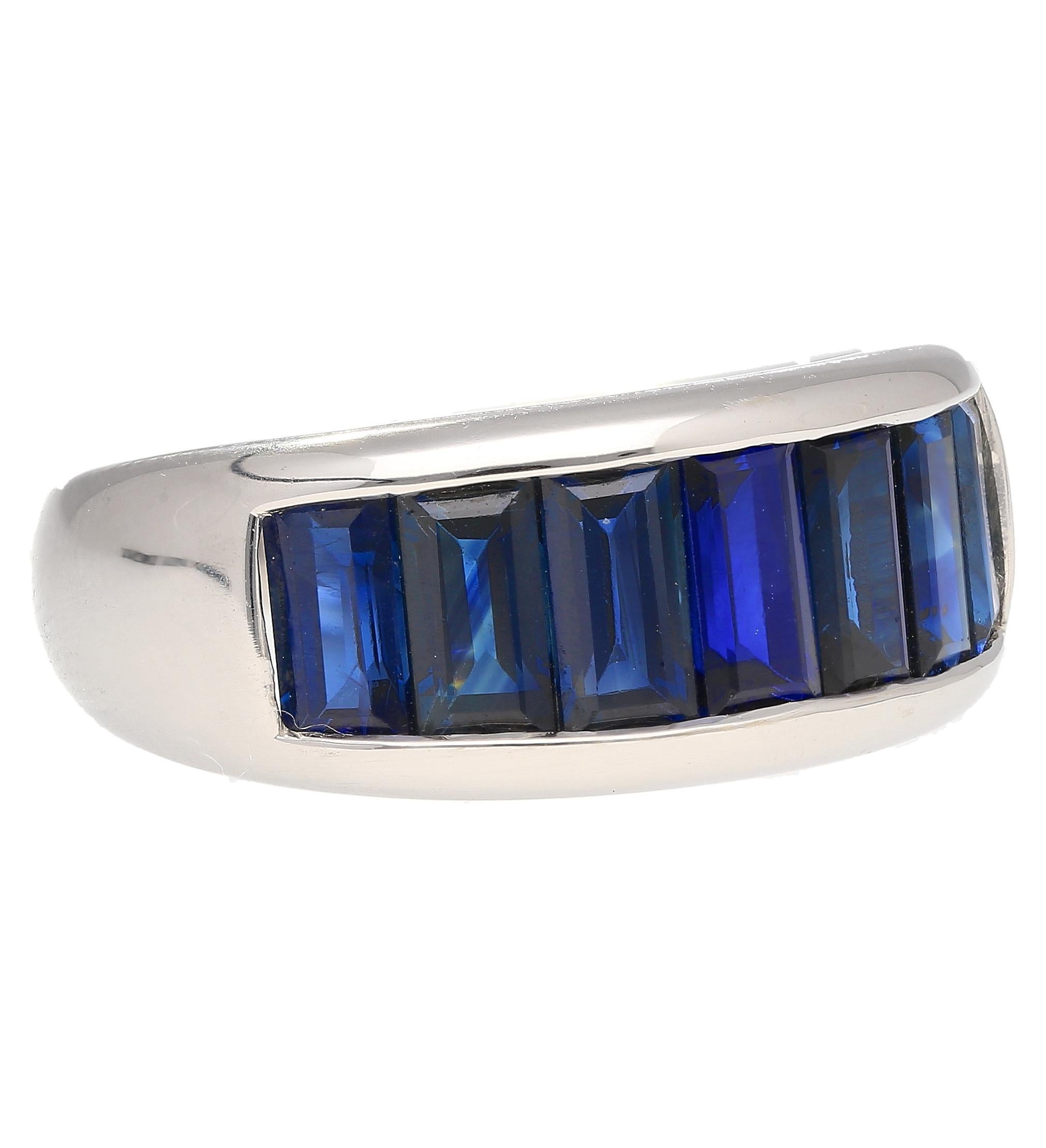 18k solid white gold sets this stunning natural baguette cut Blue Sapphire ring. The sapphires are channel tension set, with a seamless design that offers a glorious hall of mirrors effect when worn on the finger. Each sapphire features a vivid blue