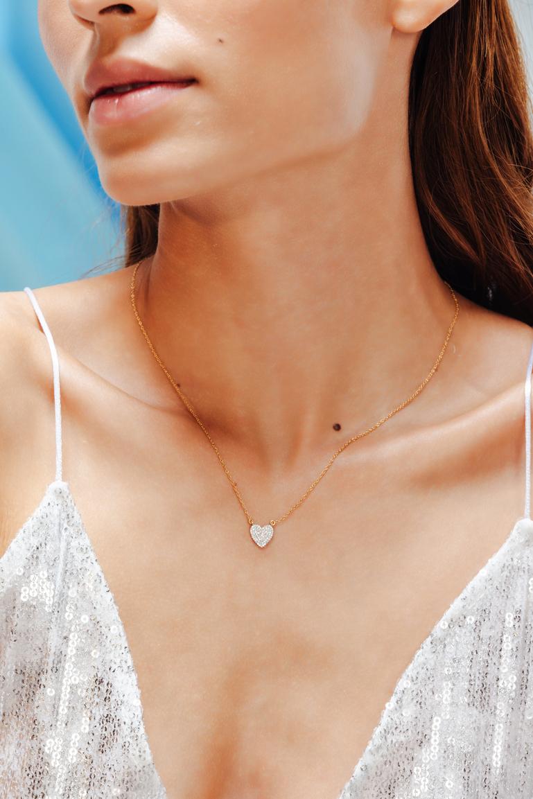 Dainty Diamond Heart Pendant Necklace in 18K Gold studded with round cut diamond. This stunning piece of jewelry instantly elevates a casual look or dressy outfit. 
April birthstone diamond brings love, fame, success and prosperity.
Designed with