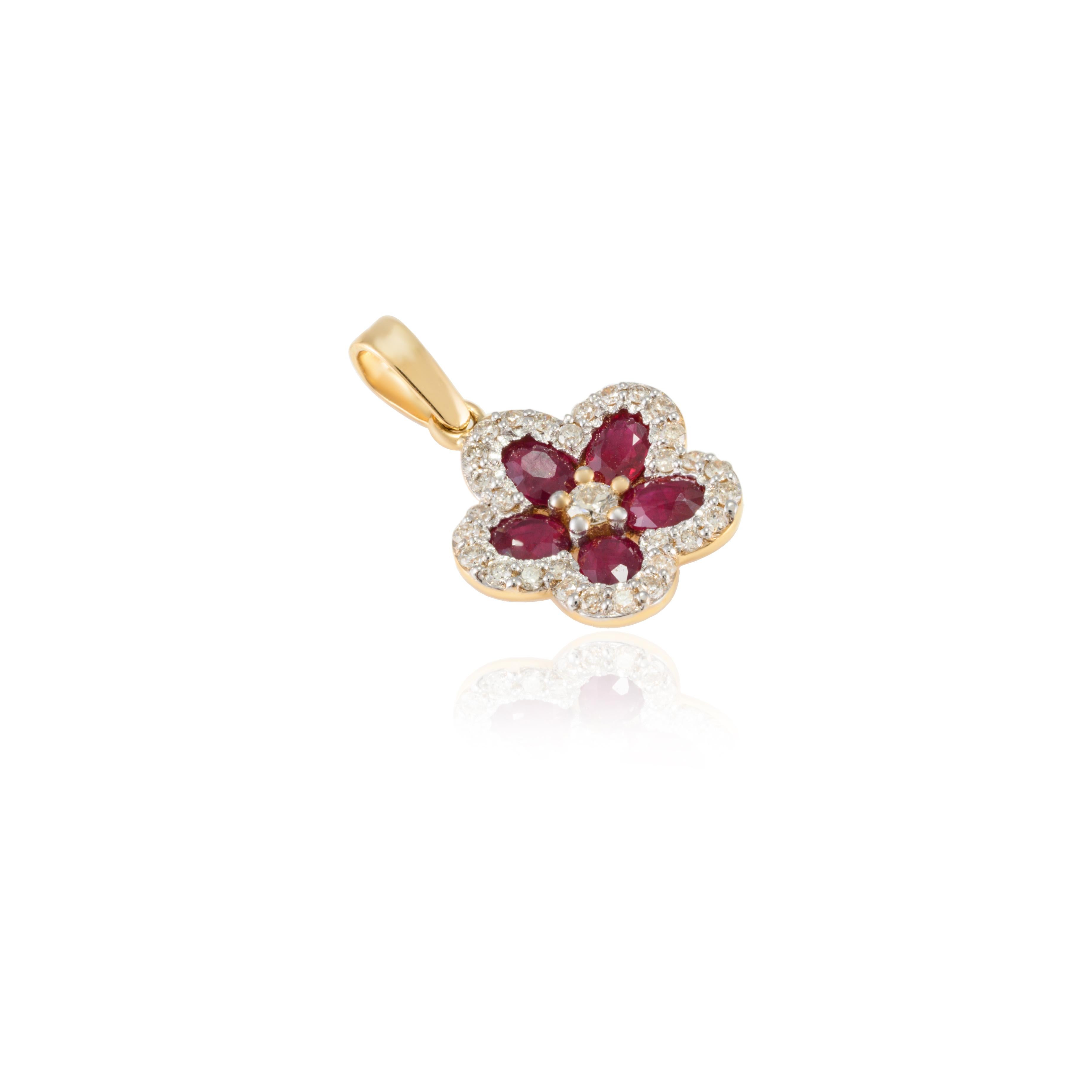 Ruby and Diamond Flower Pendant in 18K Gold studded with oval cut ruby. This stunning piece of jewelry instantly elevates a casual look or dressy outfit. 
Ruby improves mental strength. 
Designed with oval cut ruby set in solid gold making a