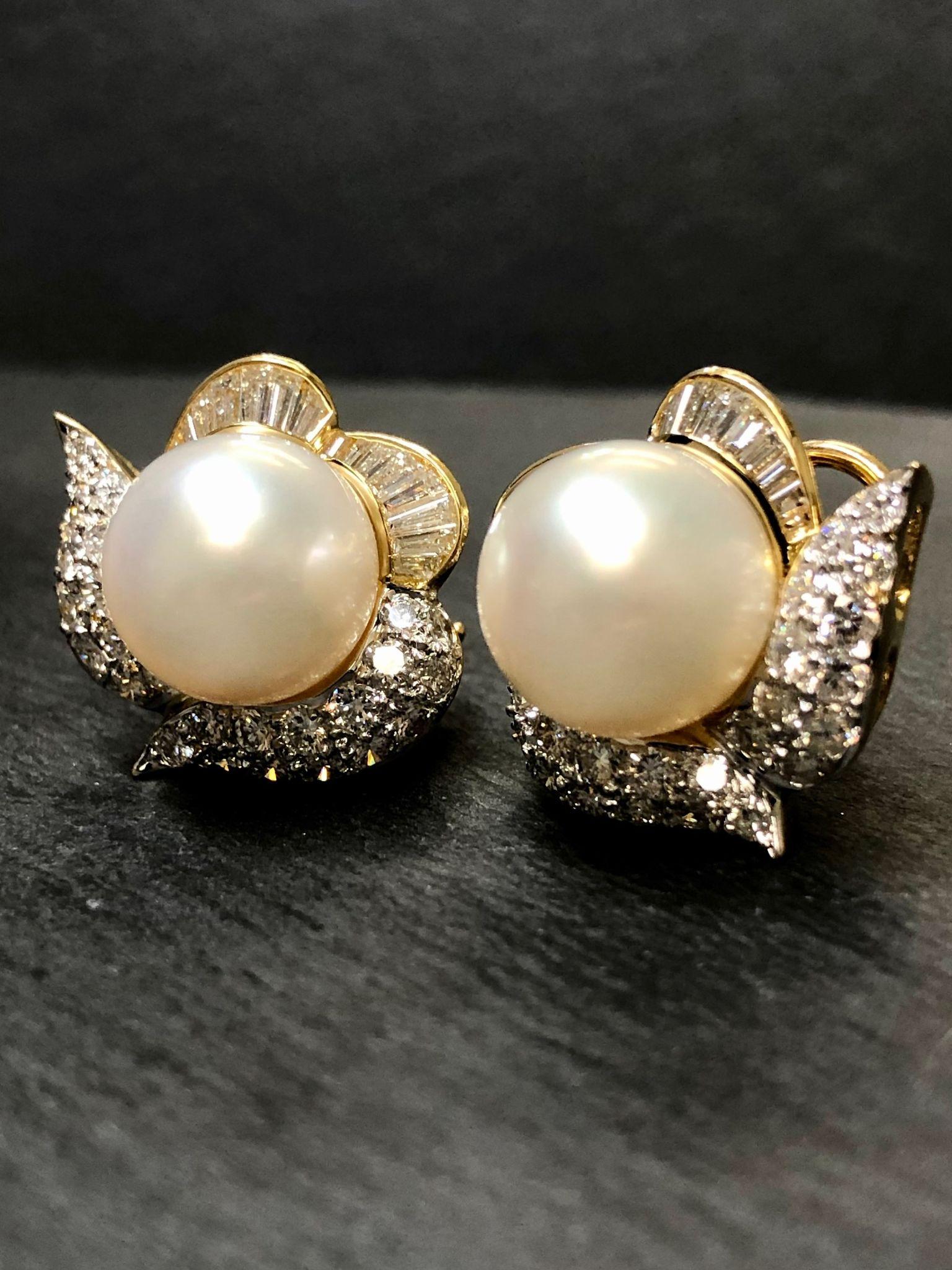 A classically elegant pair of earrings done in 18K and centered by two, 12.50mm South Sea pearls surrounded by approximately 4cttw in G-H Vs clarity round and baguette diamonds.

Dimensions/Weight
3/4” in diameter. Weighs