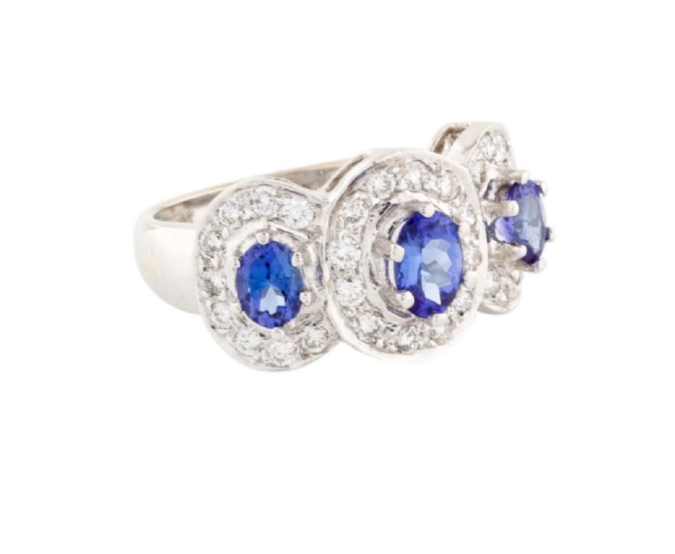 This is a gorgeous blue tanzanite and white diamond ring stamped in 18K white gold. The mesmerizing round brilliant diamonds have an excellent enhanced blue color with Oval Modified Brilliant.

*****
Details:
►Metal: White Gold
►Gold Purity: