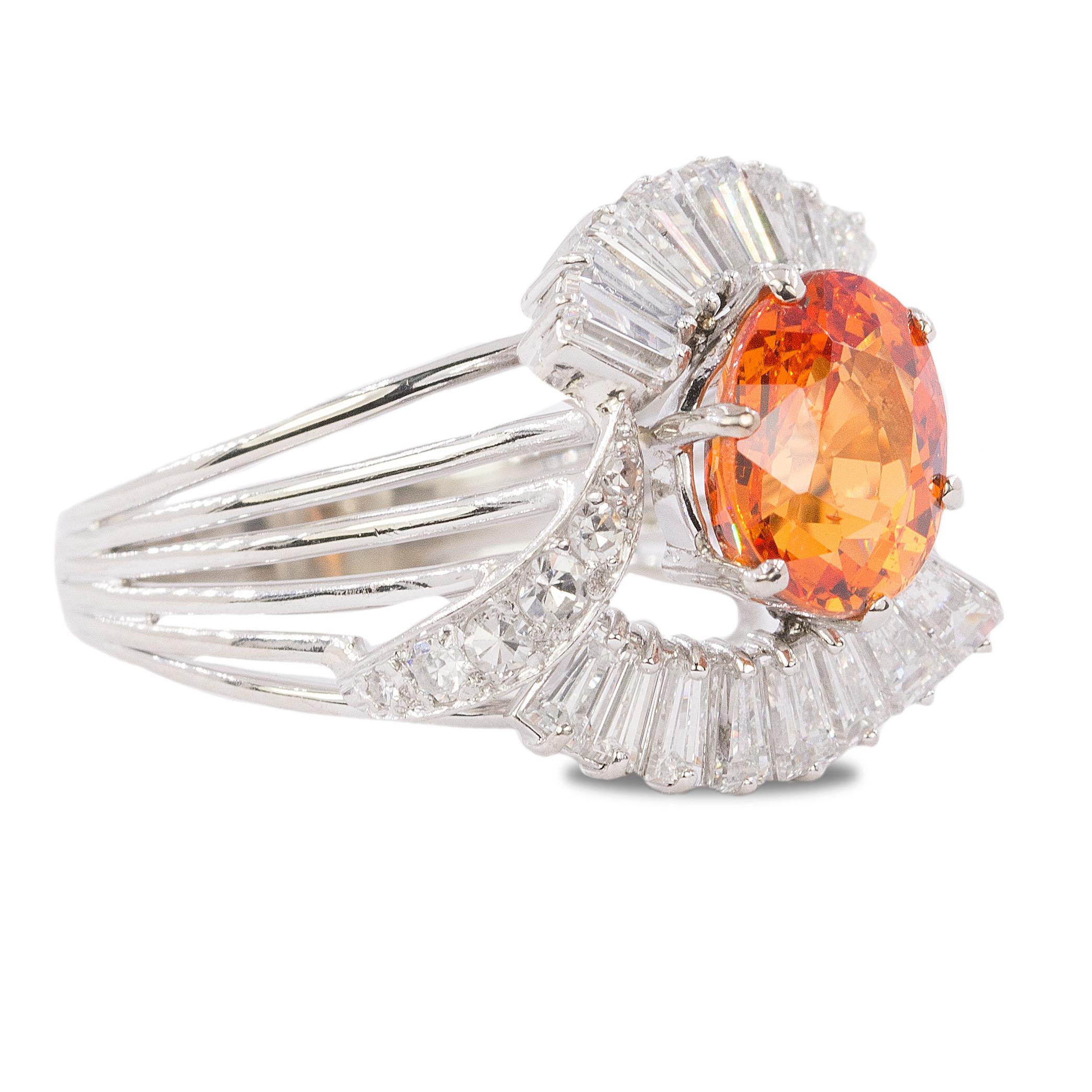 18k white gold ring with a 4.05 carat Spessartite Garnet and 16 tapered baguette and 12 round diamonds weighing approximately 1.30 carats.