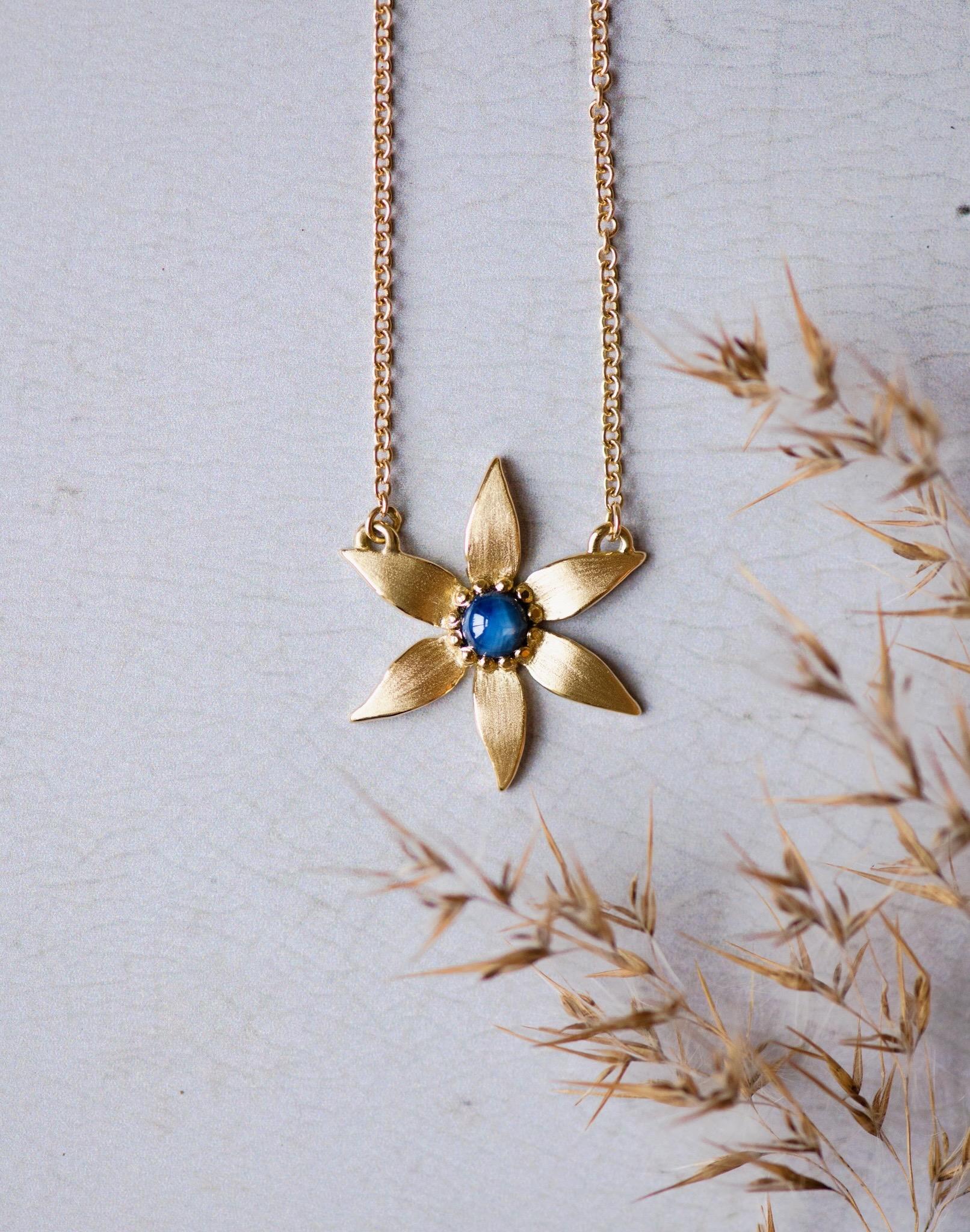 This 18K Gold Star Sapphire Flower Necklace is Made By Jennifer Rutheny in Her Small Hudson Valley, NY Workshop. It is Carved by Hand in Wax, and Cast into 18K Gold Using The Lost Wax Process. On the back of the Sapphire Necklace, You will Find The
