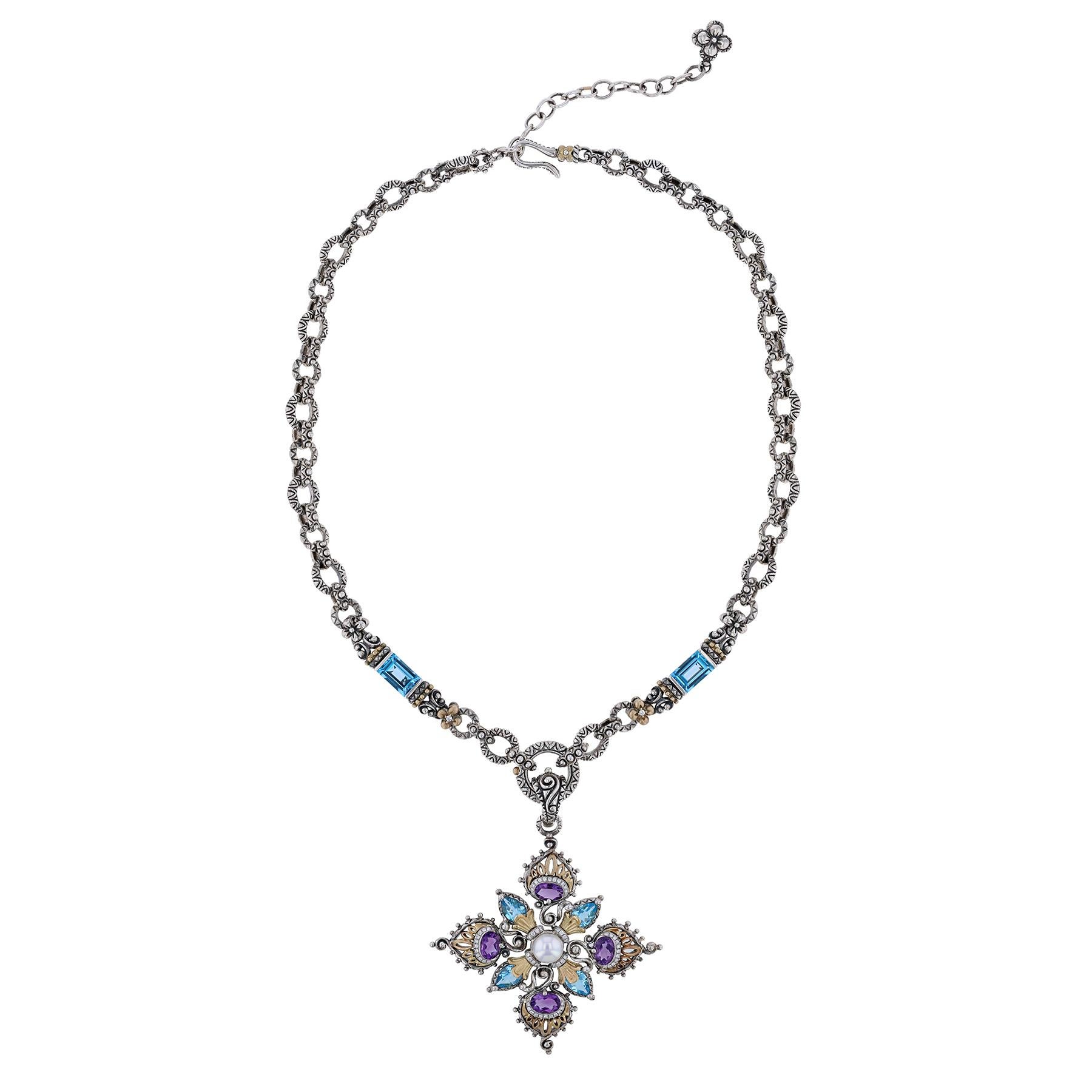 The pendant is sterling silver and 18K yellow gold peacock cross pendant. Cross features oval amethyst stones with row of pave-set round diamonds set below; marquis shaped blue topaz with 18K yellow gold endcaps and a freshwater pearl center with
