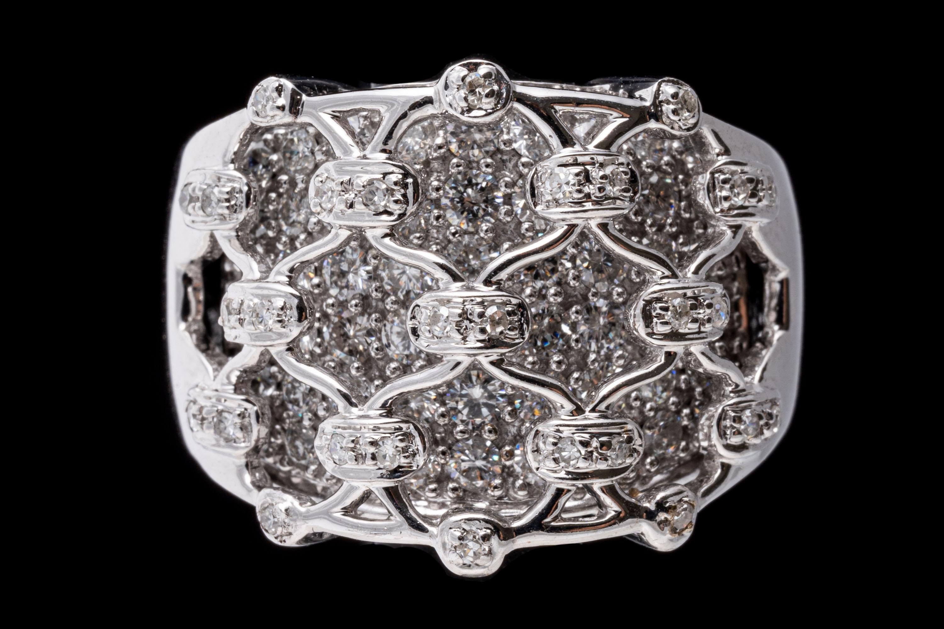 18K white gold ring. This stunning and brilliant ultra wide ring has a lace netting motif top, set with round faceted diamonds, which overlays a background of round brilliant cut diamonds for a total diamond weight of approximately 1.25 TCW.  The