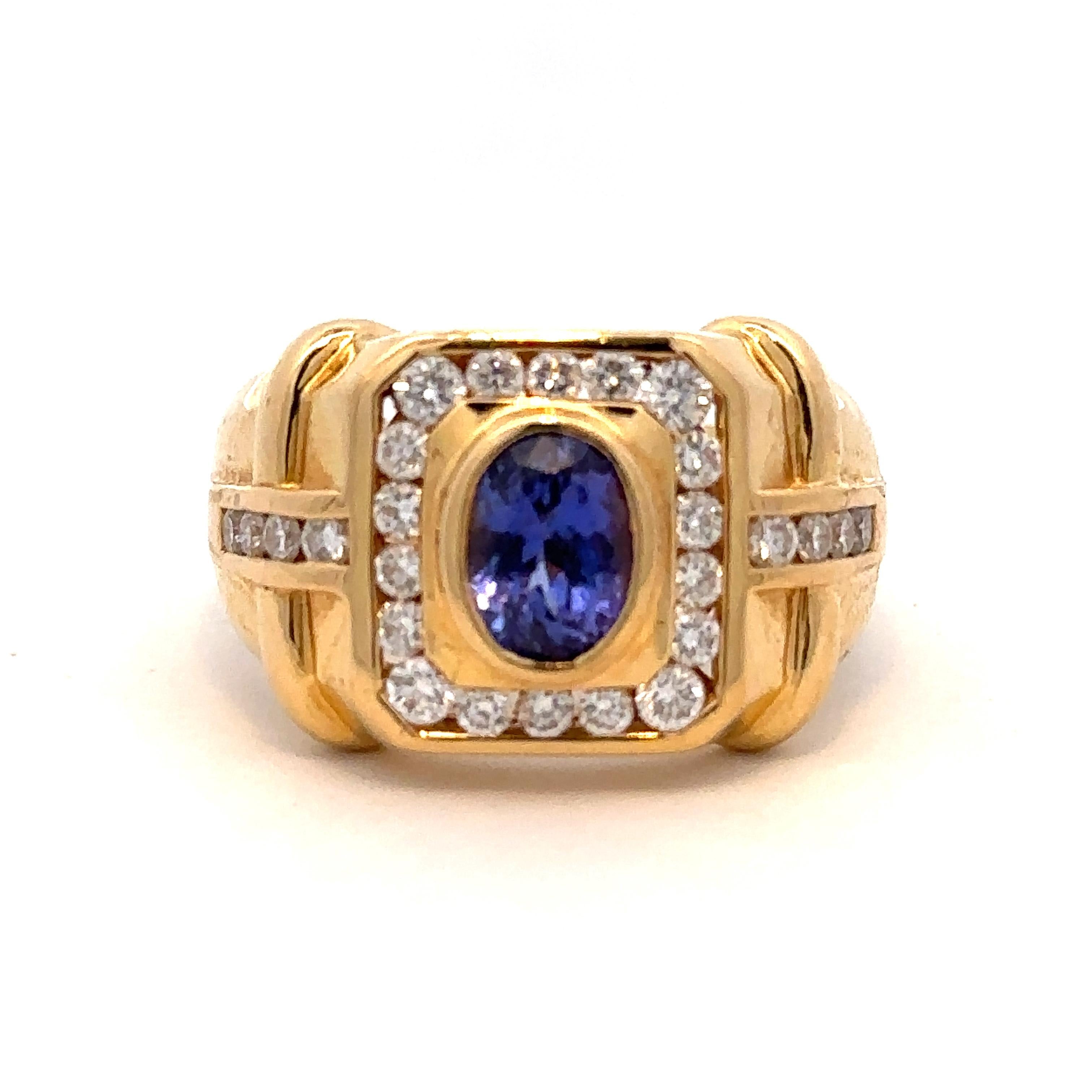 An incredible modern setting of a rich-colored tanzanite within diamonds in an 18k yellow gold ring, size 9.75 (sizeable). The tanzanite is approximately 1.5 cts and the diamonds weigh approximately 0.56 ctw (all measurements taken in setting). 