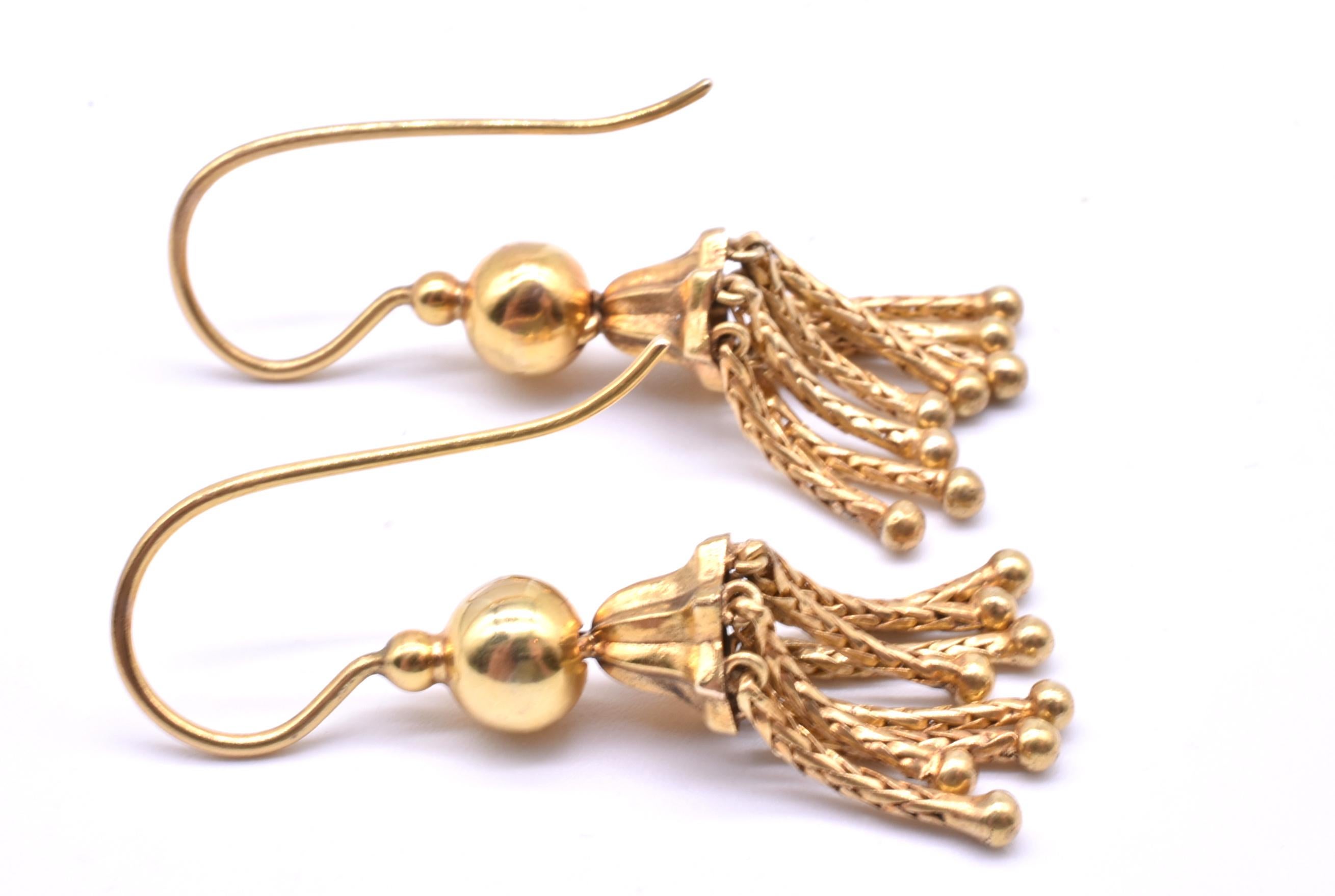 A stunning pair of 18K Victorian drop earrings with shimmering tassels with great movement and flair. The tassels create a beautiful shimmer in any kind of lighting. A small gold ball connects to the end of each tassel to give the tassels a bit of