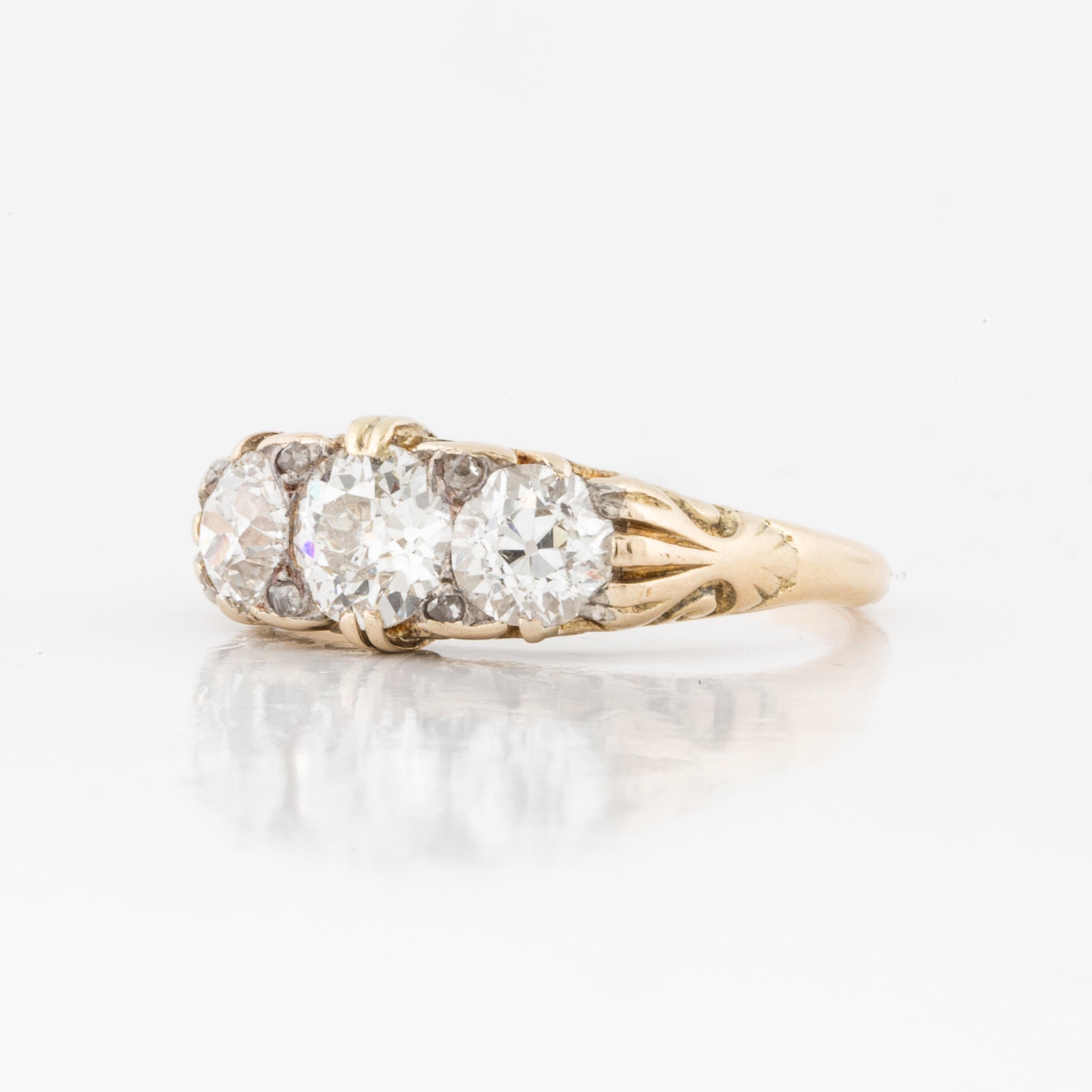 Victorian era ring composed of 18K yellow gold ring with crisp openwork and engraving featuring three Old European-cut diamonds that total 1.70 carats.  Circa 1895.  Ring is currently a size 5 3/4.  Presentation area is 5/8 inches by 1/4 inches wide.