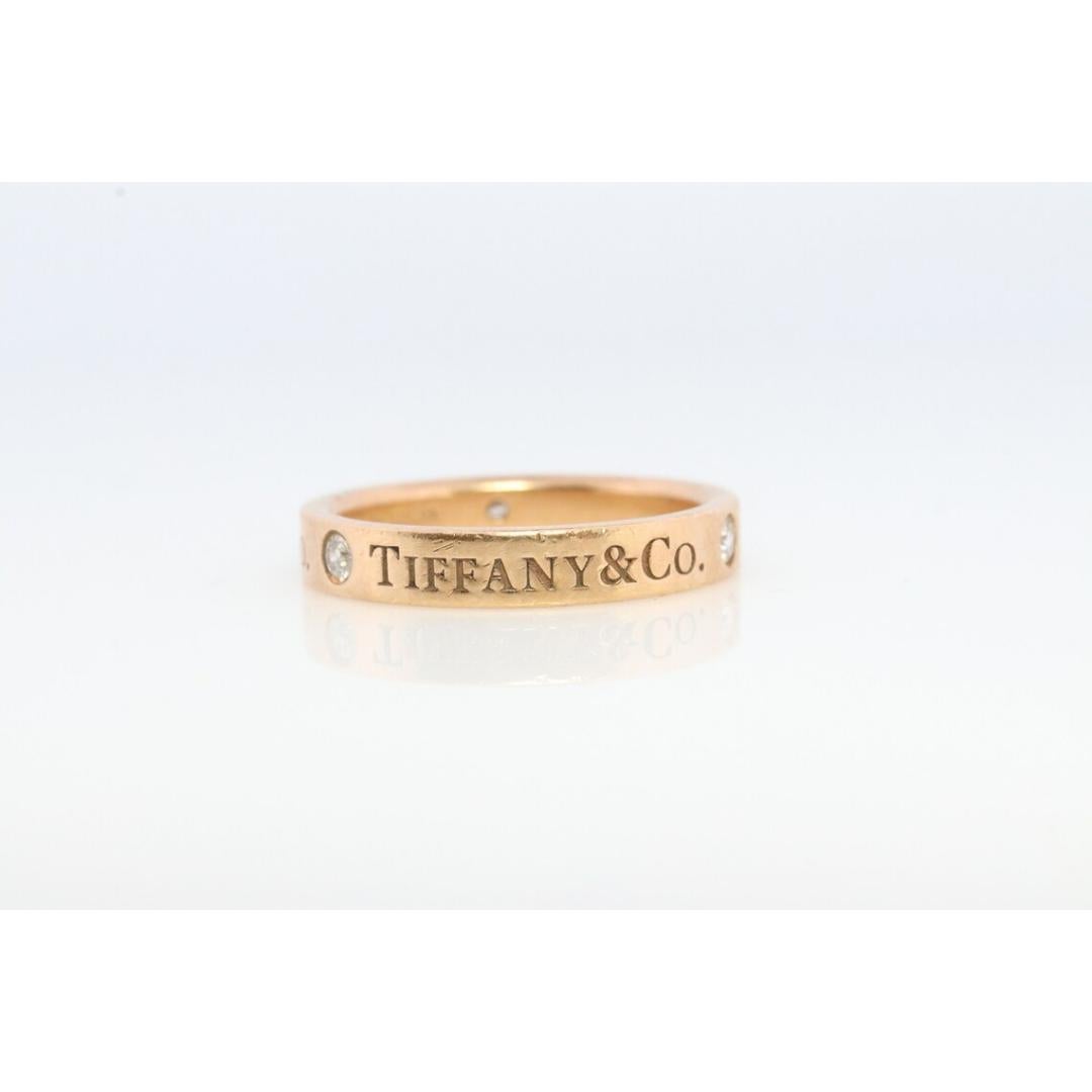 Vintage from the 1990s
Size: 4 1/2 US
Gemstone: Diamond
Gem color: Colorless

Band color: Gold

Tiffany and Co. 18k Gold band. Hallmarked Tiffany & Co. and 18k. Tests appropriately.

Three Diamond Bezel set.

Condition: Has not been polished. Has