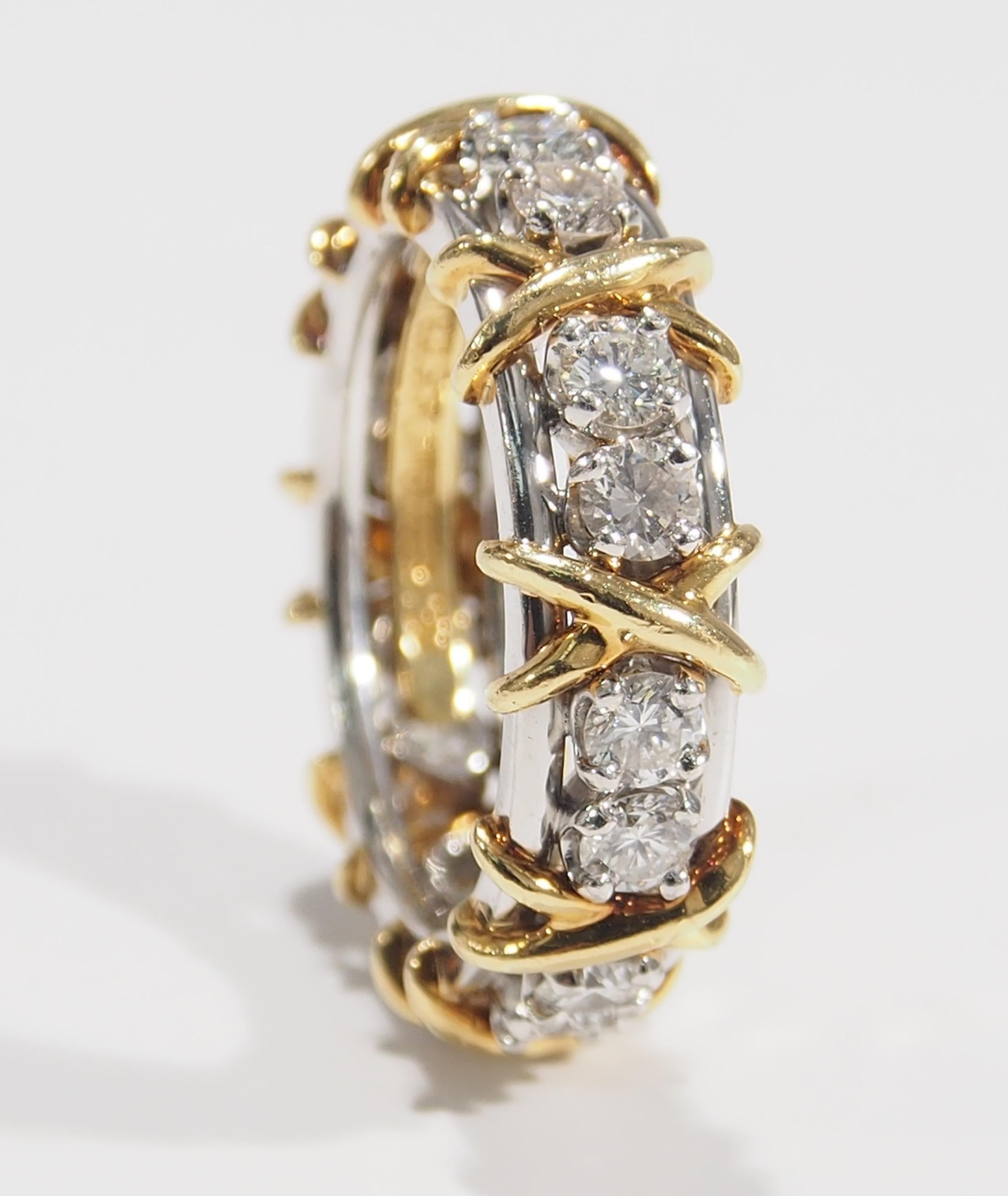 For the Tiffany & Company Schlumberger Collector is this beautifully crafted 18K White and Yellow Gold Diamond Eternity Ring. The band has (16) Round Brilliant Cut Diamonds, F in Color, VS in Clarity for approximately 1.20ctw. set in White Gold with