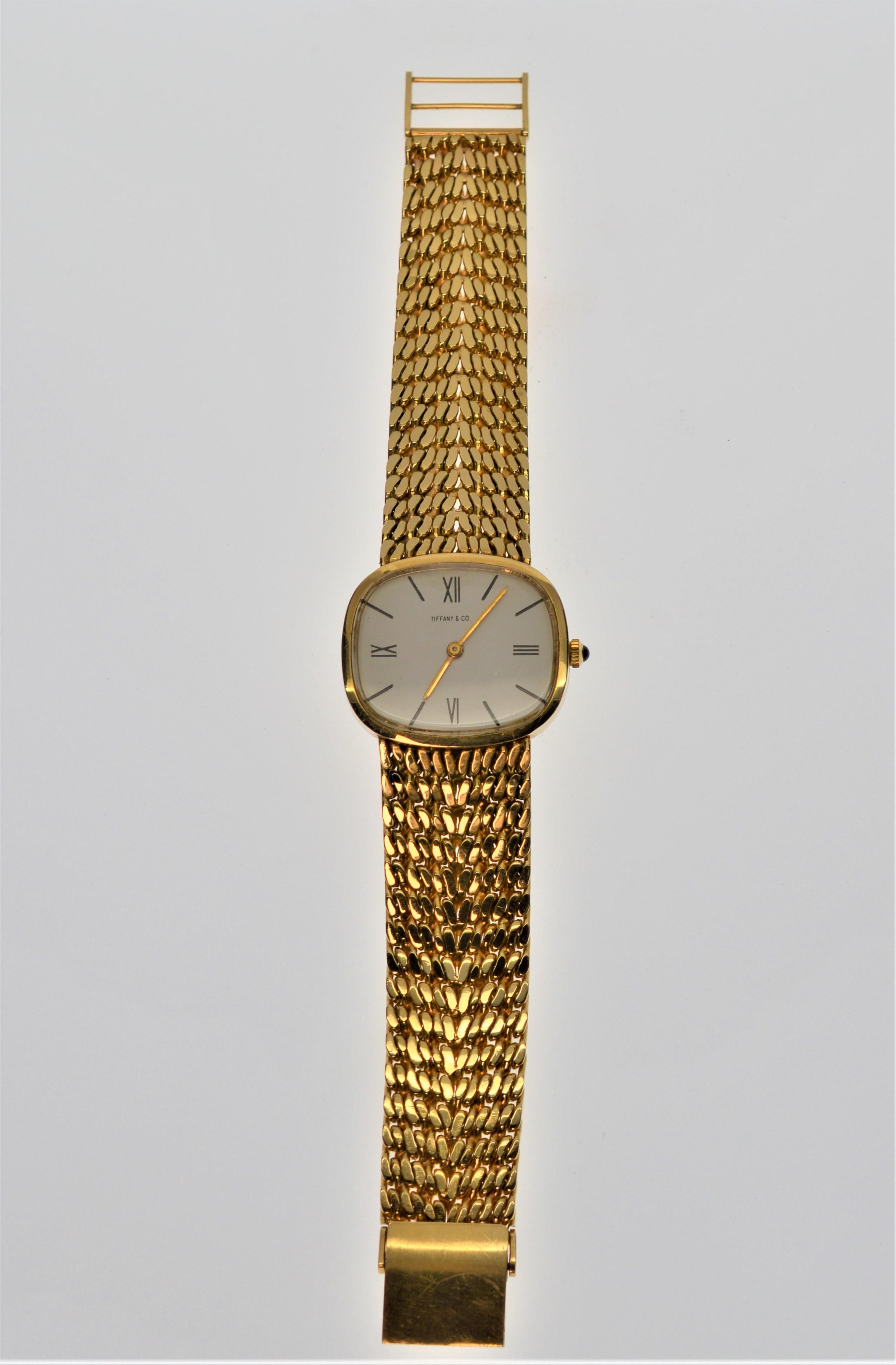 A classic, this quality Ladies timepiece from Tiffany & Co. displays an elegant fine 18K Yellow Gold Bracelet Band measuring 3/4 inch wide by 6 1/2 inch band length with 2 adjustable clip positions. Swiss 17 Jewel Mechanical Watch M&W Ullman