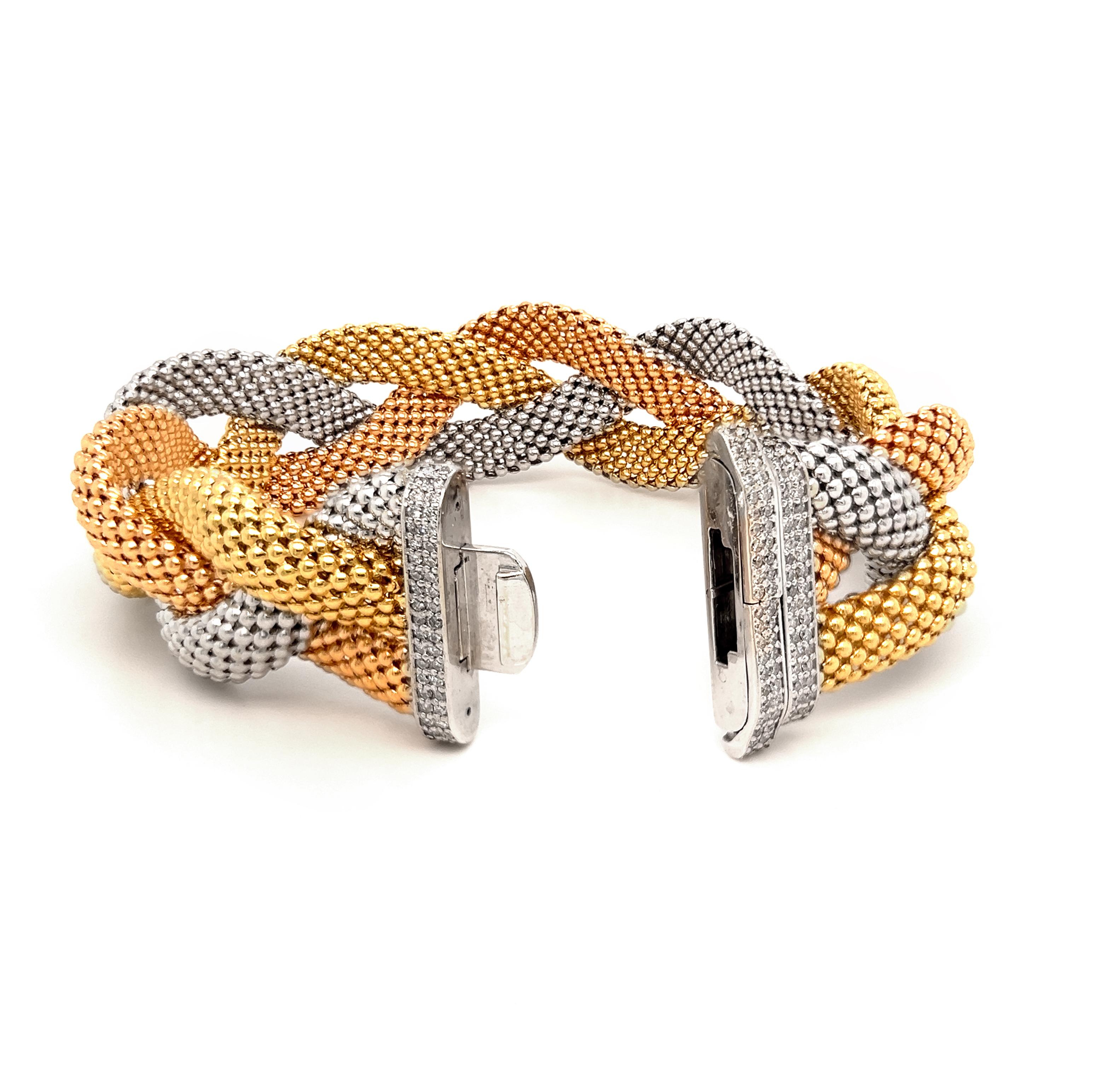 18K Tri-Color Yellow White Rose Gold and Diamond Twisted Bracelet

This Italian made bracelet features tri-color gold with a diamond buckle to clasp in the center. Yellow white and rose gold chains are twisted together to form this stunning, unique