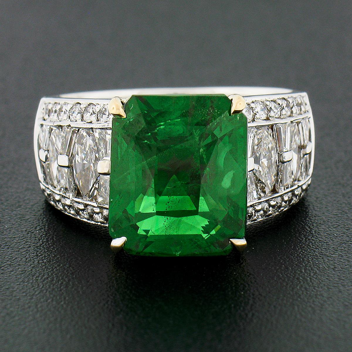This absolutely breathtaking tsavorite and diamond ring was crafted in solid 18k white gold with a solid 18k yellow gold center basket that carries a gorgeous, emerald cut, natural tsavorite stone. The large solitaire is perfectly prong set and GIA