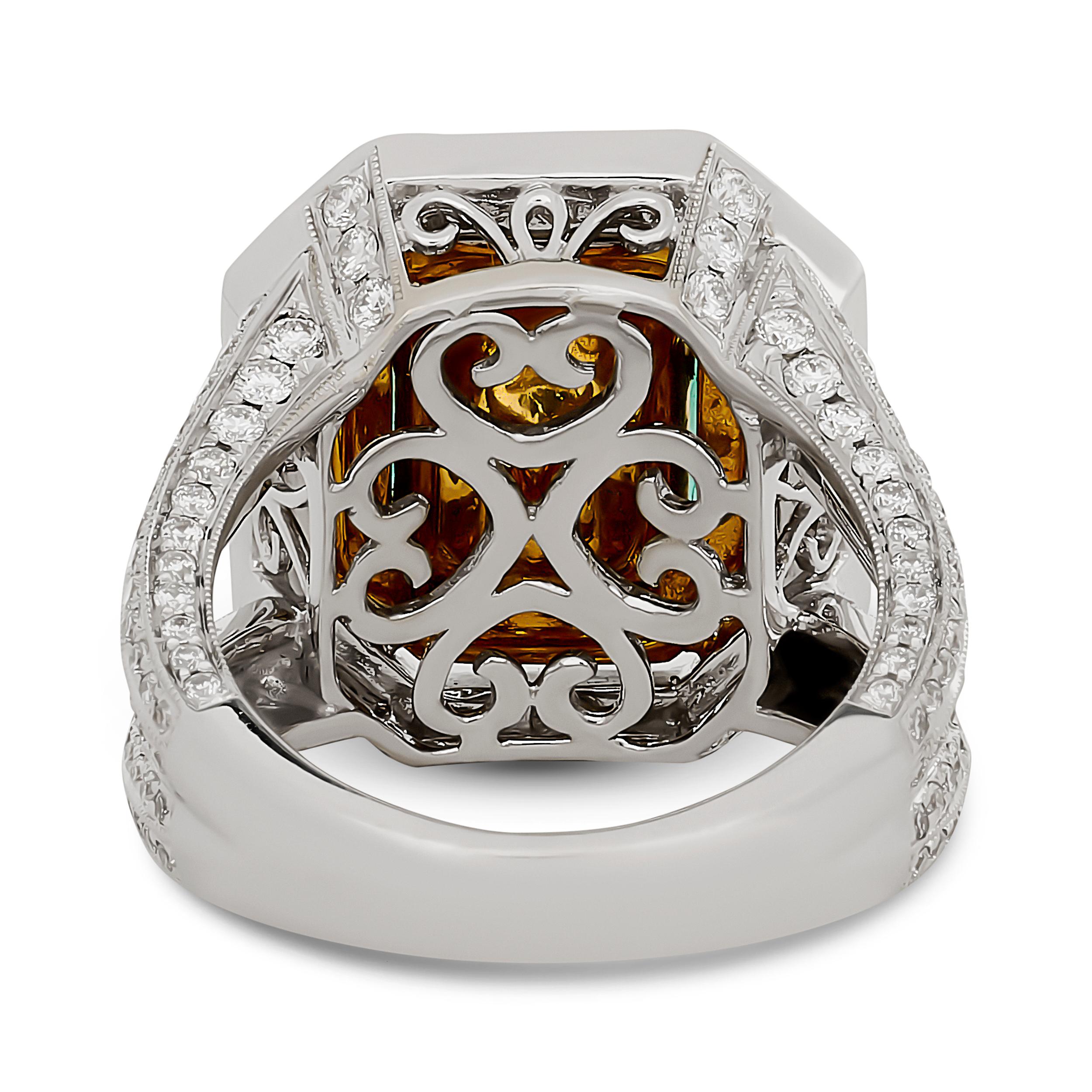 This magnificent ring features a captivating emerald-cut Colombian emerald, elegantly framed by a dual halo of dazzling diamonds, with the inner halo accented by warm gold prongs, all set on a diamond-encrusted split shank band.

The center emerald