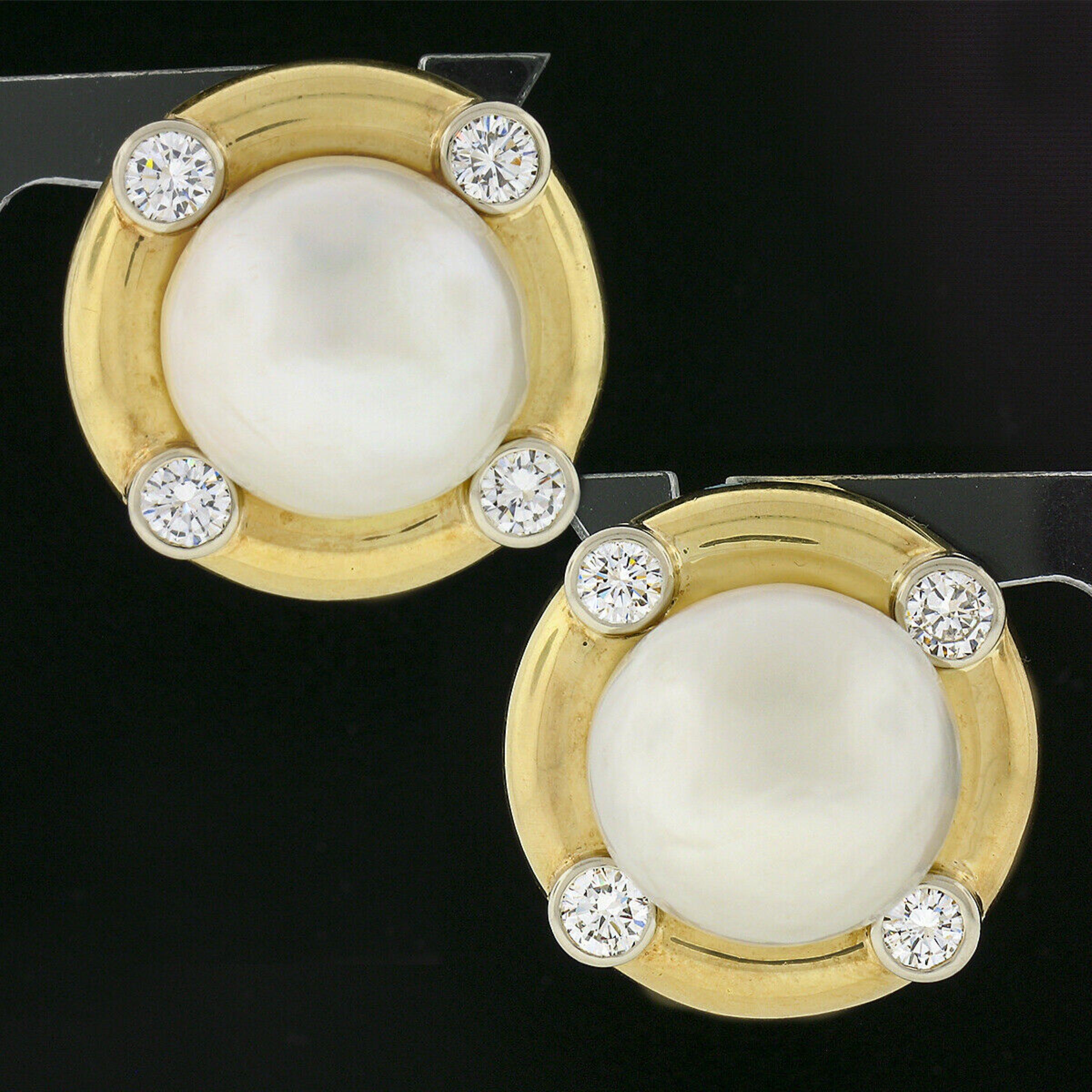 This magnificent pair of button statement earrings was crafted from solid 18k yellow and white gold. They each feature a very large, GIA certified, saltwater cultured pearl at their center, surrounded by a high polished finish frame adorned with